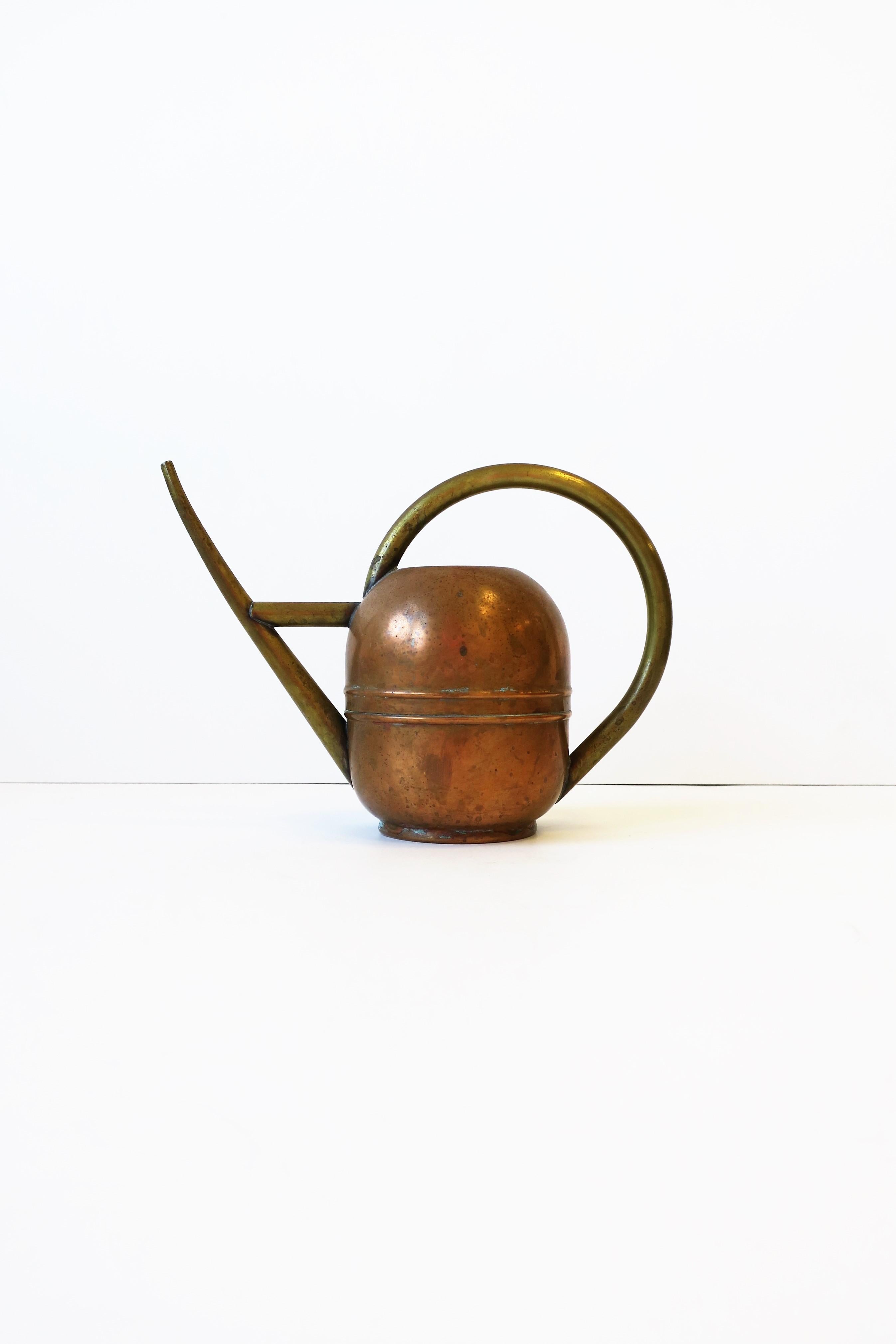 A beautiful American Art Deco period 1930s brass and copper watering can by the Chase Brass and Copper Company Inc., circa early 20th century, USA. Piece is beautifully designed; handle and spout are brass and container, copper. Great for