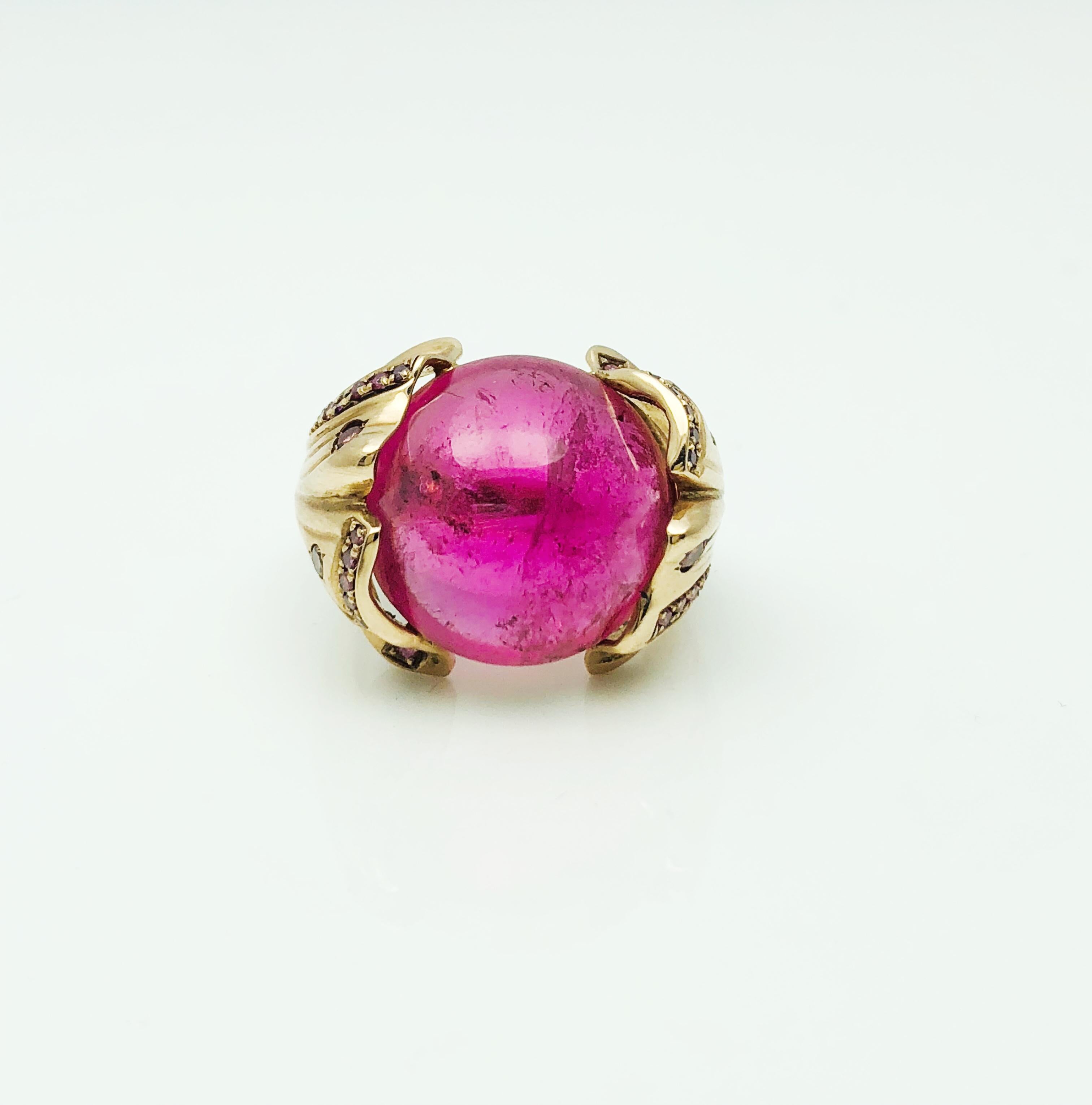 This Babette Shennan Ring is an absolute show stopper! It is from her Ginkgo Collection. Made in 14K Rose Gold with a stunning antique, satin finish! At the center of this ring is a beautiful, bubble gum colored, 17.03 mm Cabochon Rubelite