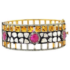 Designer Bangle with Ruby and Sapphire Set Surrounded by Pave Diamonds