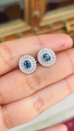 Designer Blue Sapphire Stud Earrings with Halo of Diamonds in 14K White Gold
