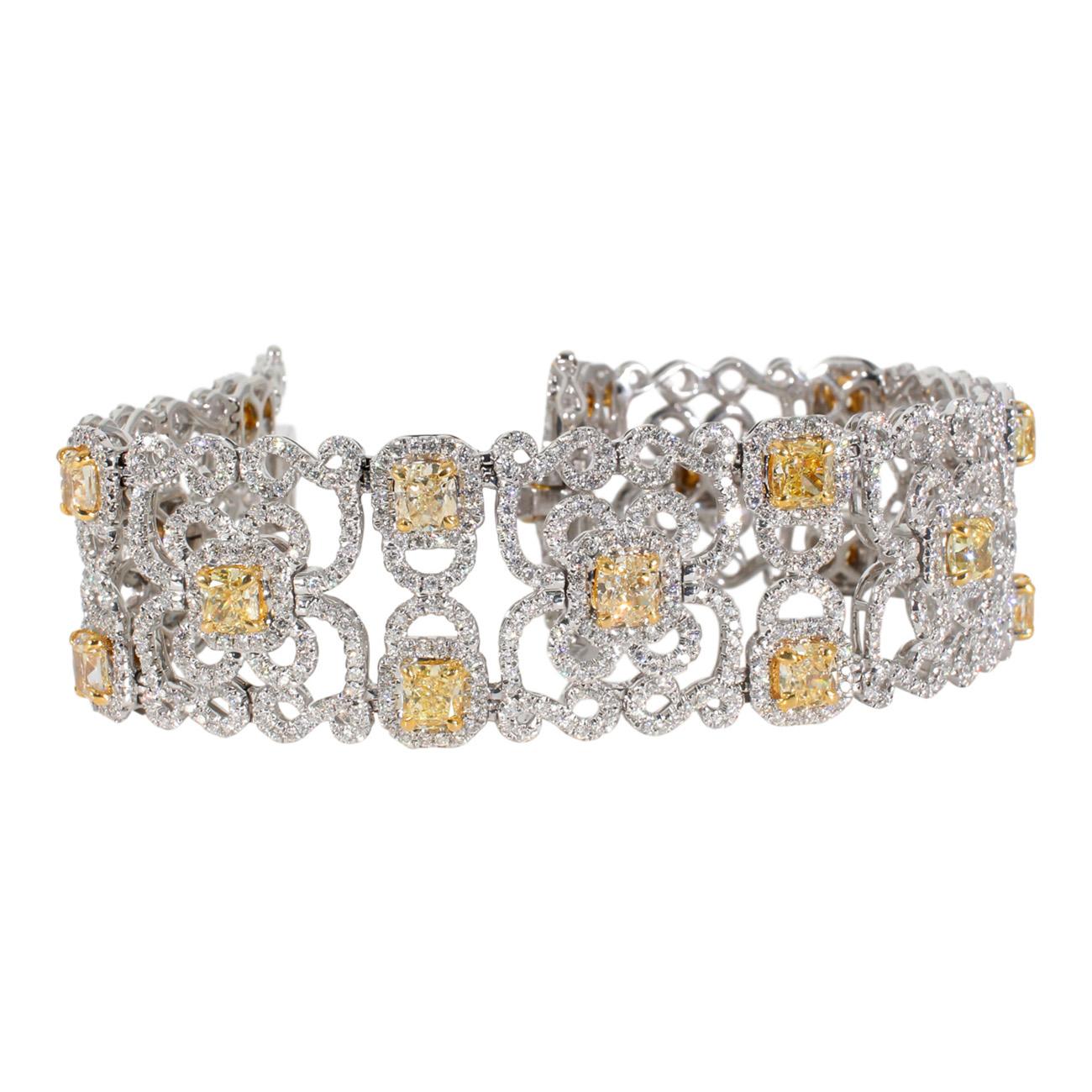 Designer bracelet in 18K white gold with French pave set rounds around prong set fancy yellow cushion cut diamonds.  D17.73ct.t.w.