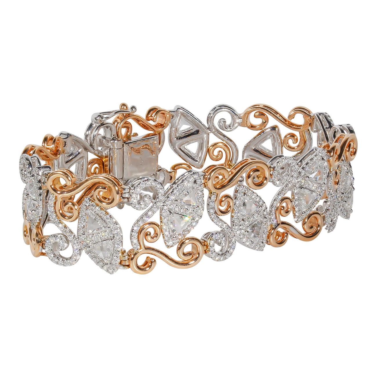 Designer bracelet in 18K two-tone with swirly rose gold lining, French pave set rounds around prong set trilliant cut diamonds.  D7.94ct.t.w.
