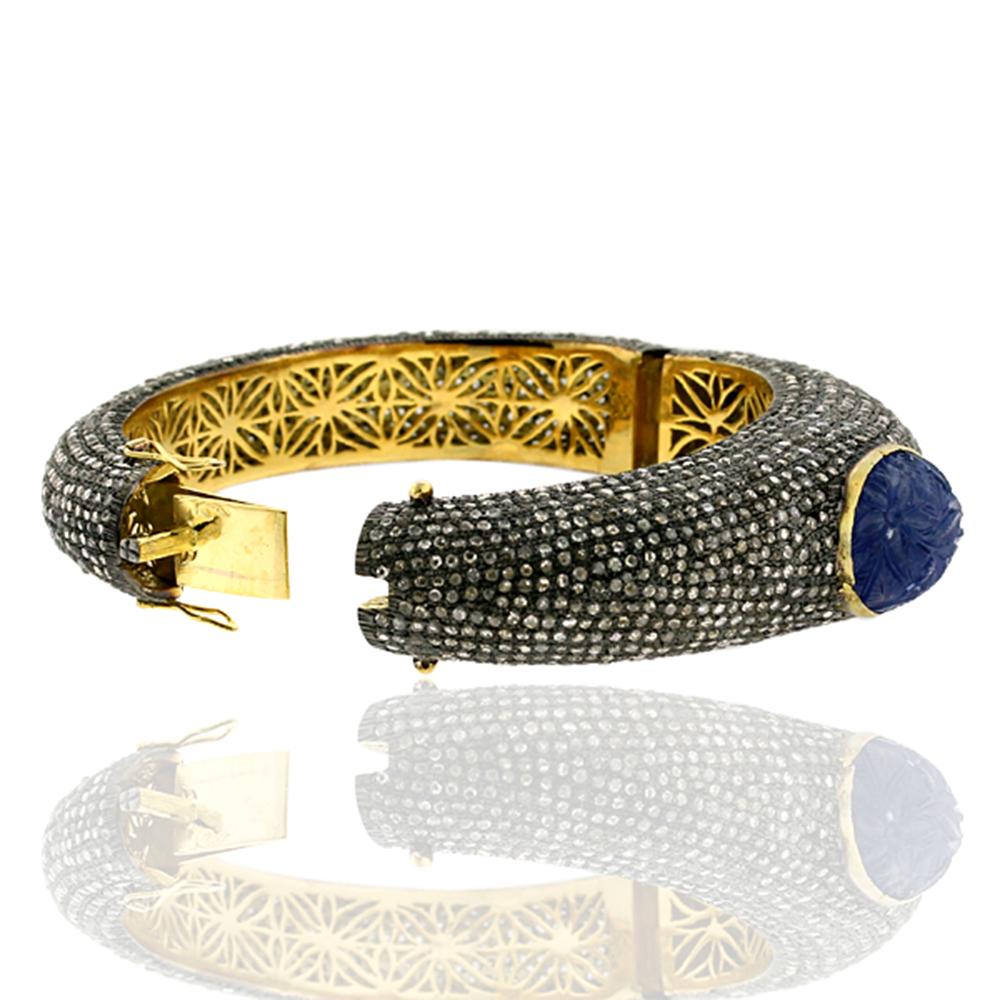 Art Nouveau Graduating Pave Diamond Bangle With Carved Tanzanite In Center For Sale