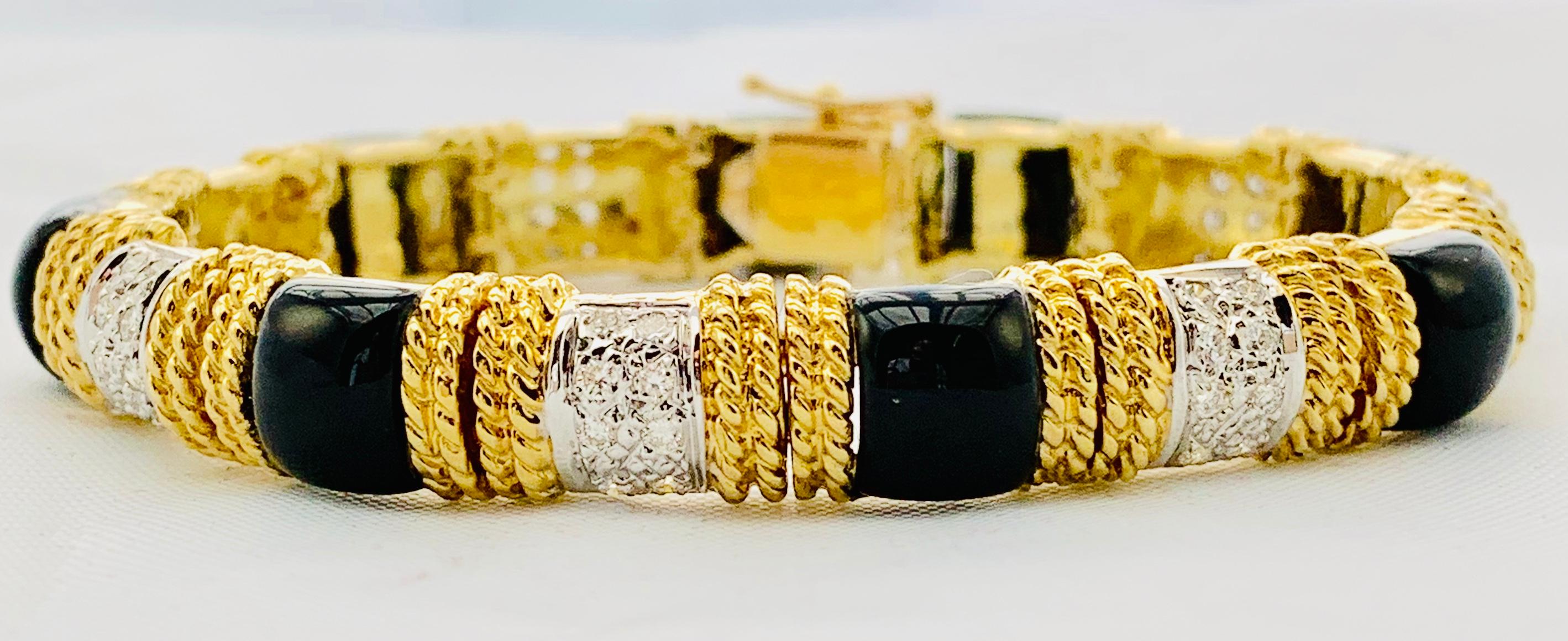 Gorgeous Designer Cassis Section Bracelet! It is made in 18K Yellow Gold. This piece has 8 sections of inlaid Black Onyx and 7 Diamond Sections. Each Diamond Section has 8 round diamonds that are G-H in color and Vs Clarity and have an estimated
