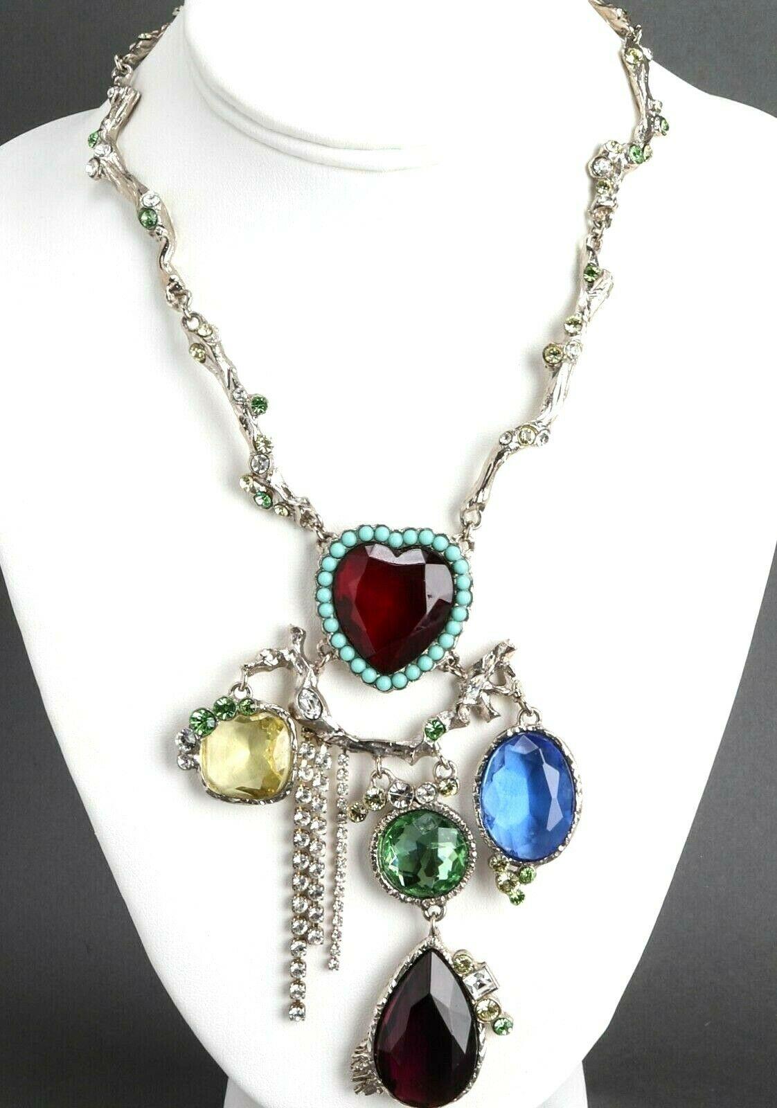 Simply Fabulous! Christian Lacroix Jeweled Multi Charm Necklace. Branch motif Pendant Necklace featuring five large faceted faux Gemstones including one faux Amethyst Heart. Silver-tone mounting. Necklace measures approx. 17.5