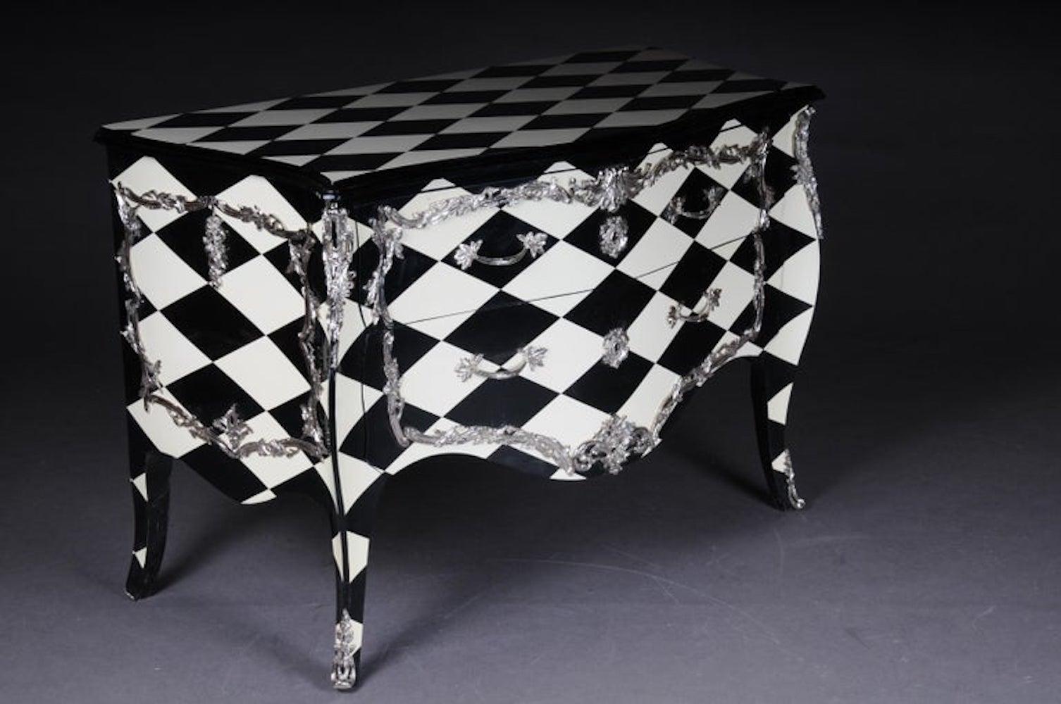 Designer Commode in Louis XV, chessboard pattern.

Solid wood on all sides and black and white painted chess tiles on the top. Slightly cambered body with extended corner strakes on a deeply lowered frame, ending over high curly legs in bronze caps.