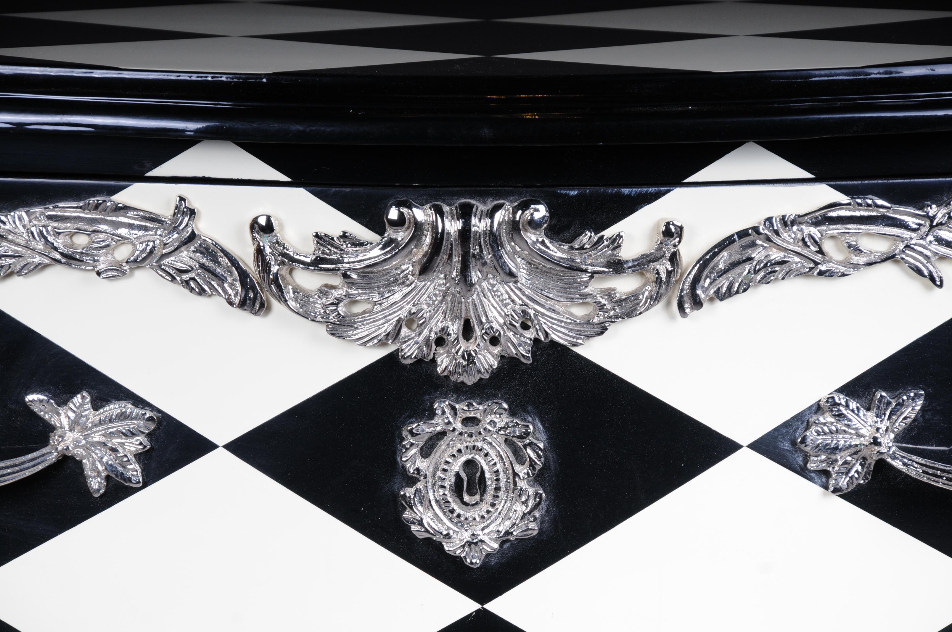Designer Commode in Louis XV, chessboard pattern.

Solid wood on all sides and black and white painted chess tiles on the top. Slightly cambered body with extended corner strakes on a deeply lowered frame, ending over high curly legs in bronze