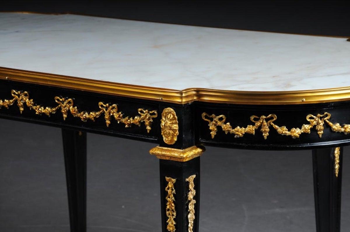 Designer couch table in Louis XVI black, white marble

Solid beechwood painted black and with gilded bronze. Slightly protruding inserted white marble slab. Extremely decorative

