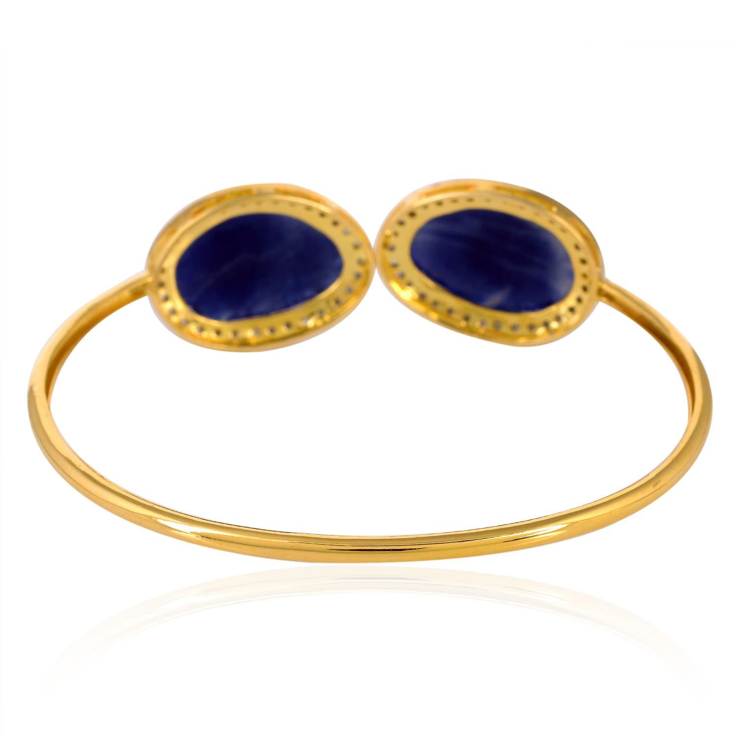 Modern Designer Cuff Bracelet with Blue Sapphire Stones Surrounded by Pave Diamonds For Sale