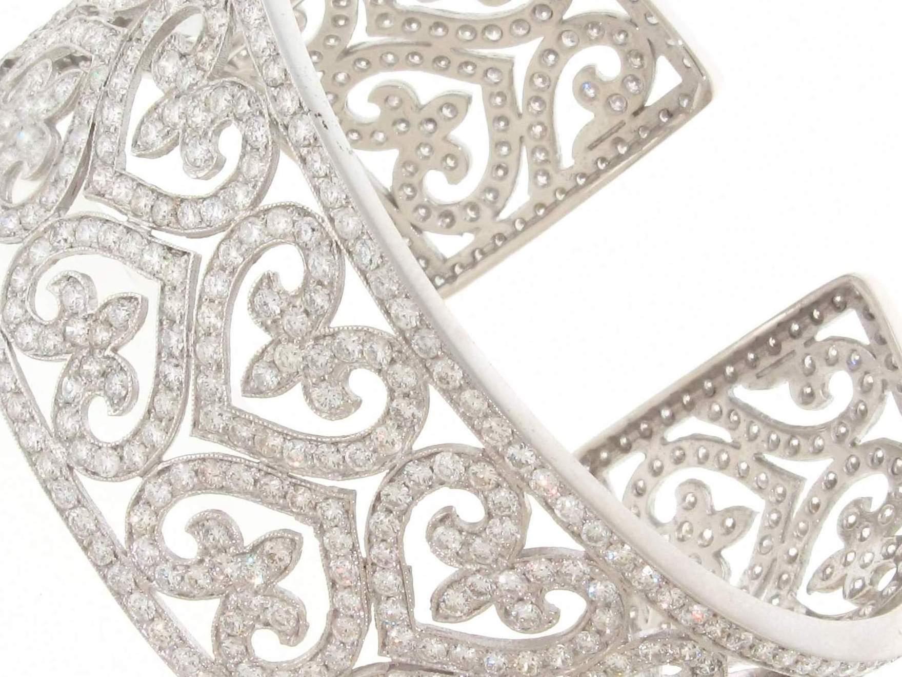 Designer cuff bracelet in 14K white gold with detail, pave set round diamonds in a heart design.  D6.55ct.t.w.