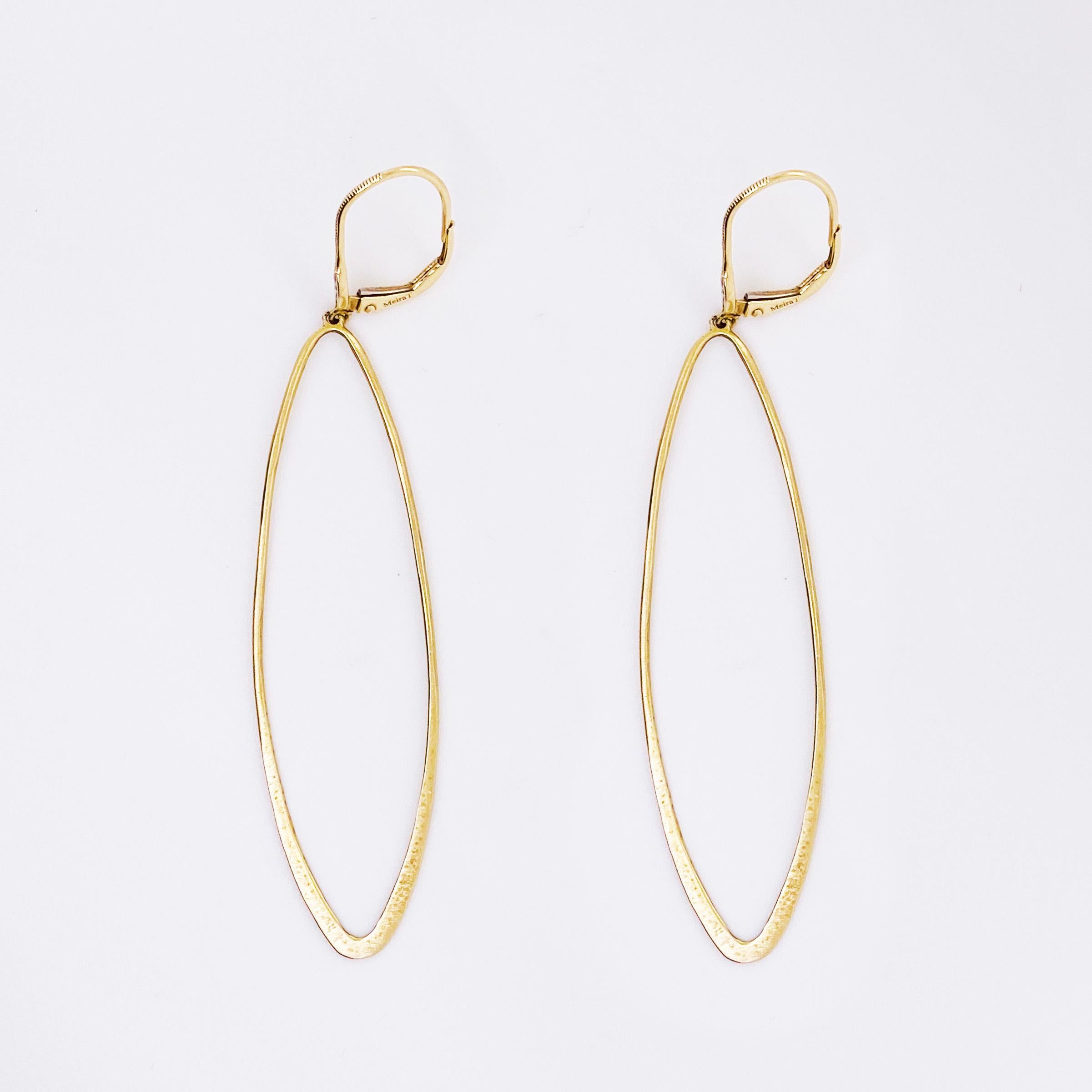 Diamond fashion earring dangle! The dangle earrings are an elongated oval design with a satin finish and diamond sparkle. 

Metal Quality: 14K Yellow Gold
Earring Type: Dangles
Earring Measurements:
Diamond: .02 Carat total diamond weight
Diamond