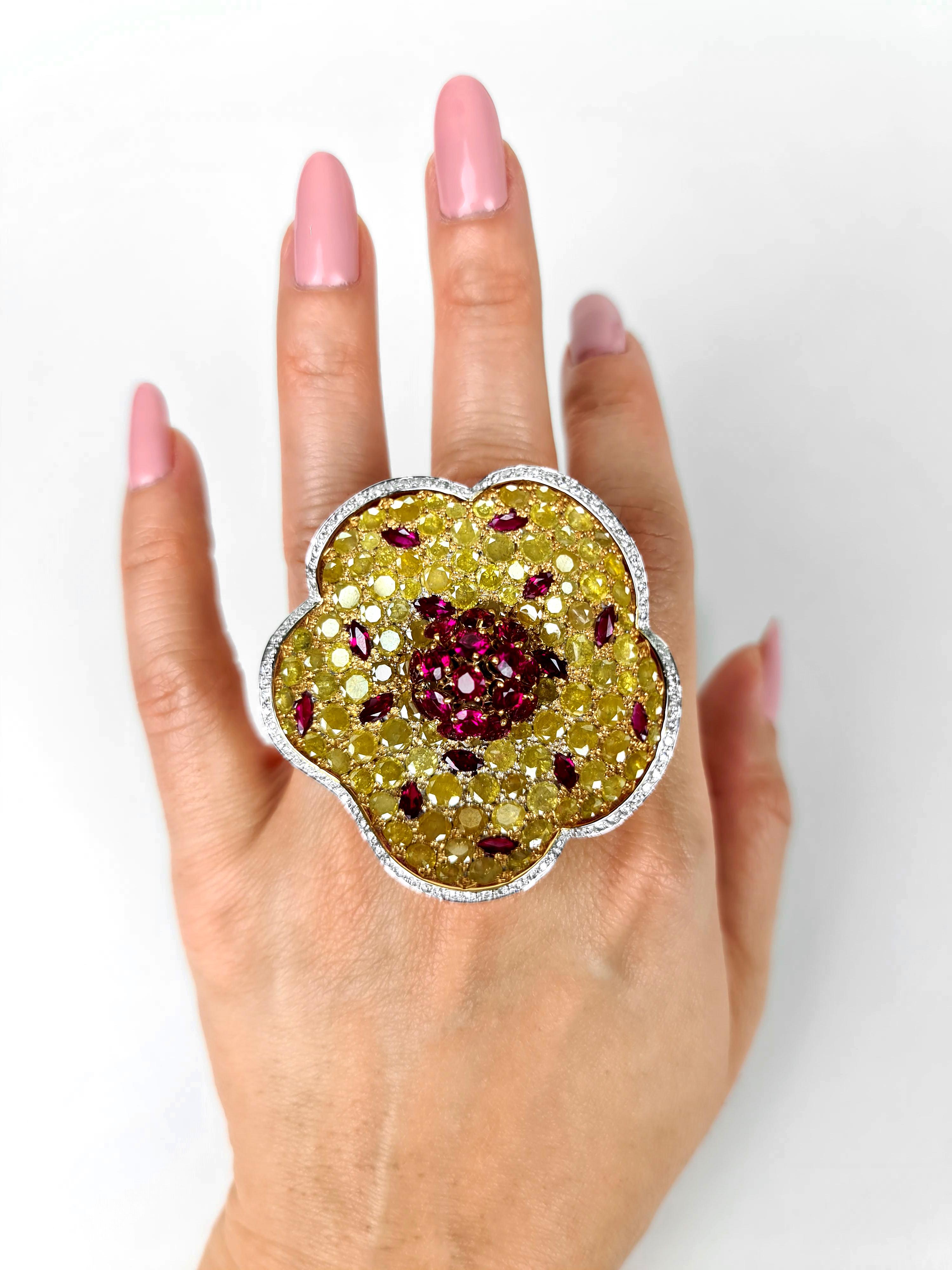 Stunning white, yellow diamond, and ruby ring set in 18-carat white gold, created by legendary luxury Swiss jeweler De Grisogono. Stand out from the crowd with this explosive blooming motif as the huge, bold, flamboyant flower bursts at the very