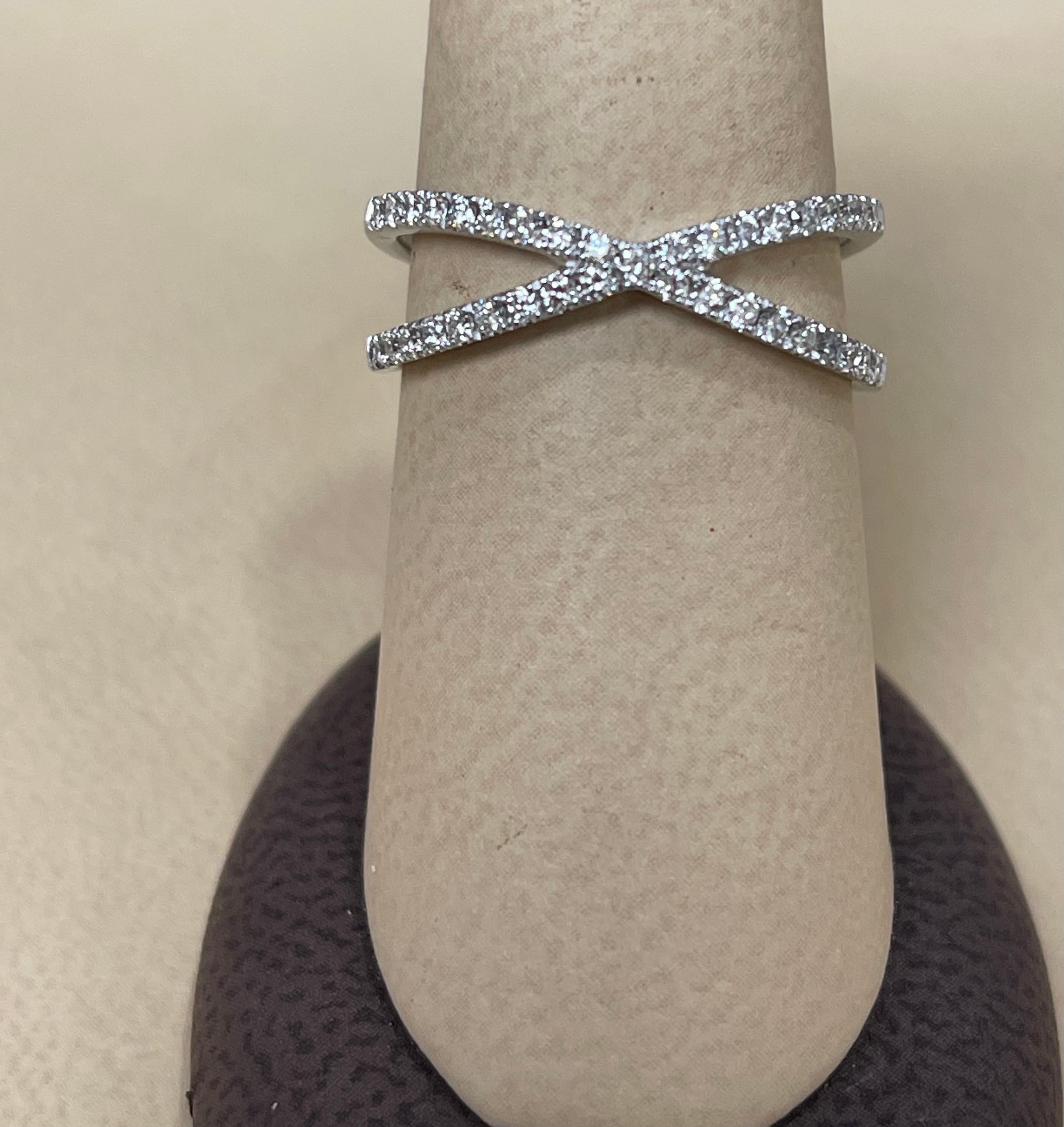 Designer Effy's 0.40 Carat Diamond  Cross over Cocktail Ring 14Karat White Gold

4    I  pointer
32   1.1 pointer 
1 1.2 pointer
Total 0. 40 ct  Brilliant cut round diamonds .
two bands are crossing over

Diamond SI to VS  quality and G/H Color
This