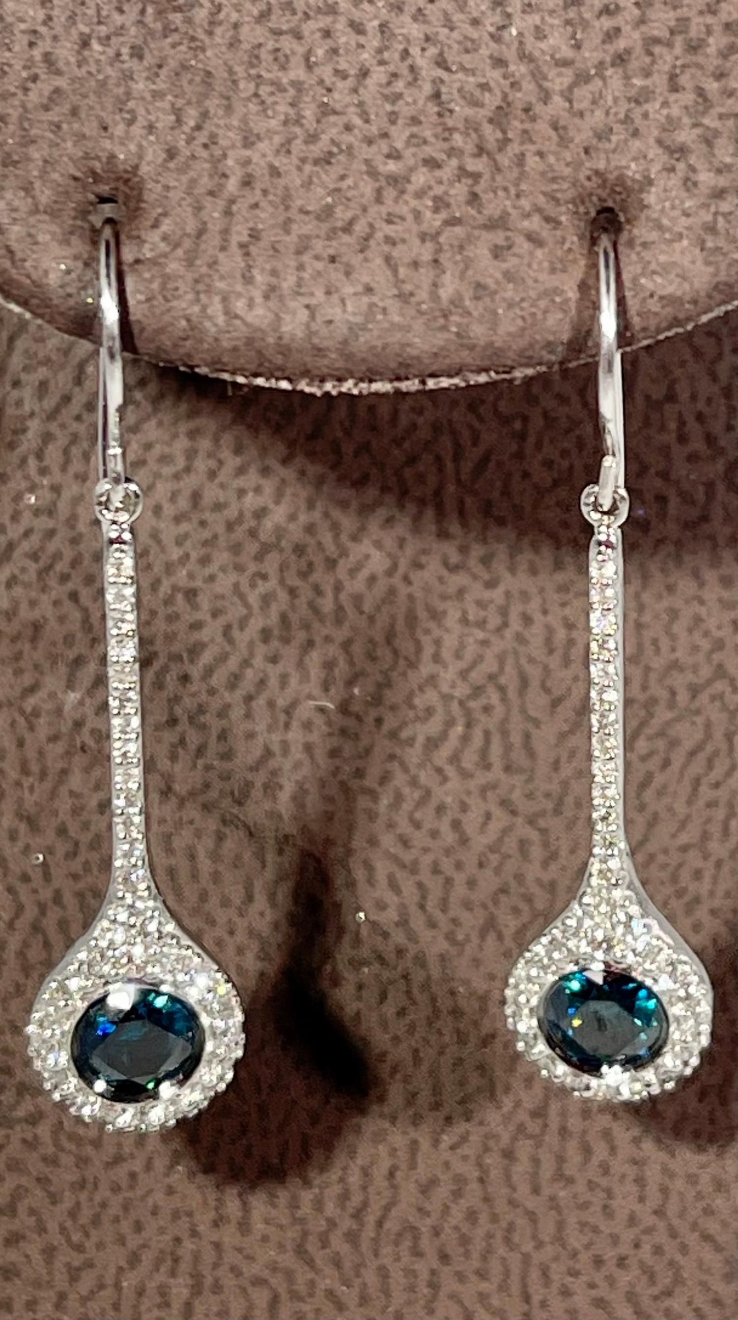 
Designer Effy's 1.57 Carat Blue & White Diamond Dangling Earrings 14K White Gold
 Fish Hook 
This exquisite pair of earrings are beautifully crafted with 14 karat White  gold .
Weight of 14 K gold 3.1 grams
Fine Round Cut Blue diamonds are