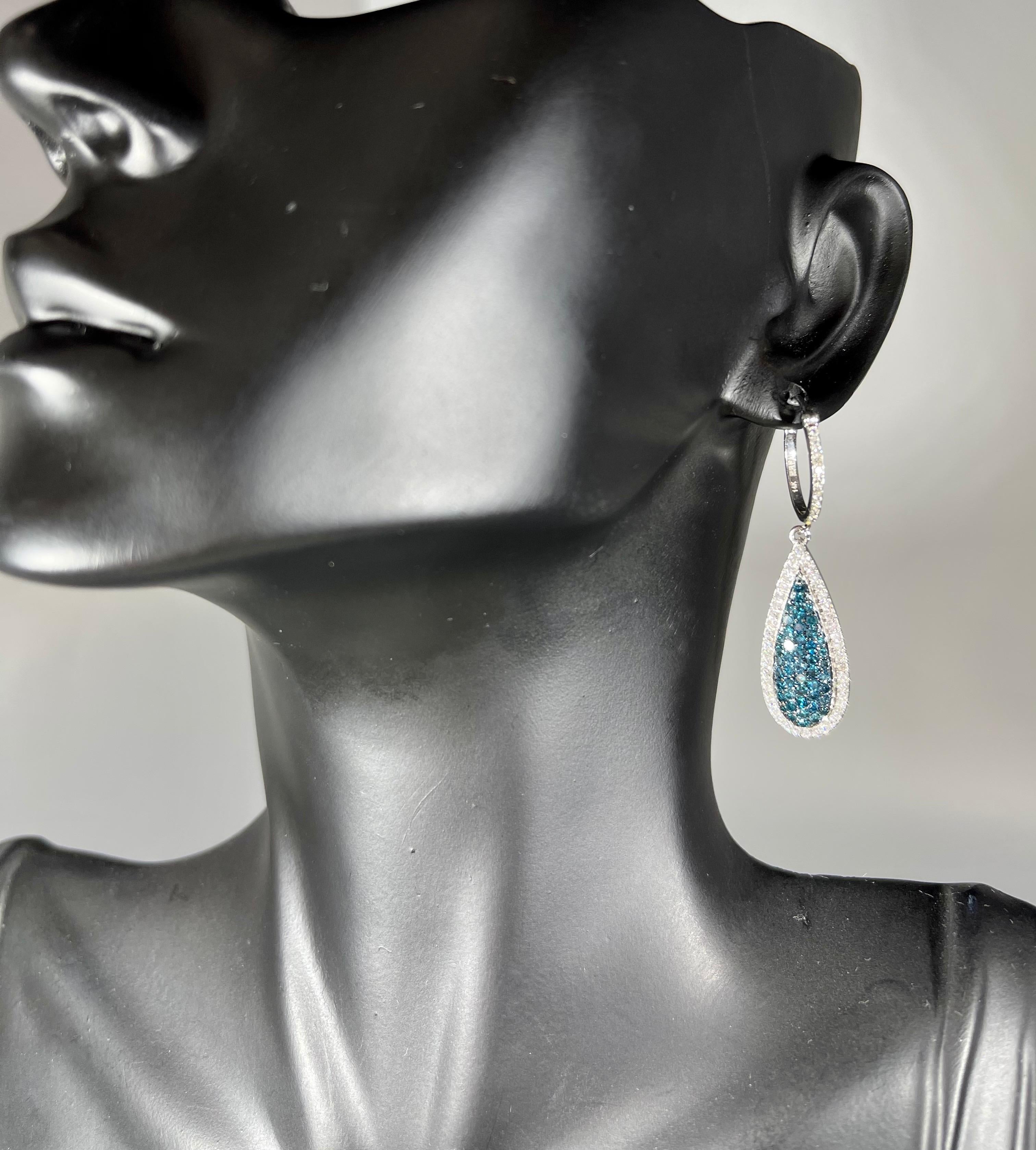 
Designer Effy's Natural Blue and White Diamond Dangling Earrings 14K White Gold
 Small Huggies on the top . 
This exquisite pair of earrings are beautifully crafted with 14 karat gold .
Weight of 14 K gold 4.5 grams
Fine Round Cut Blue diamonds are