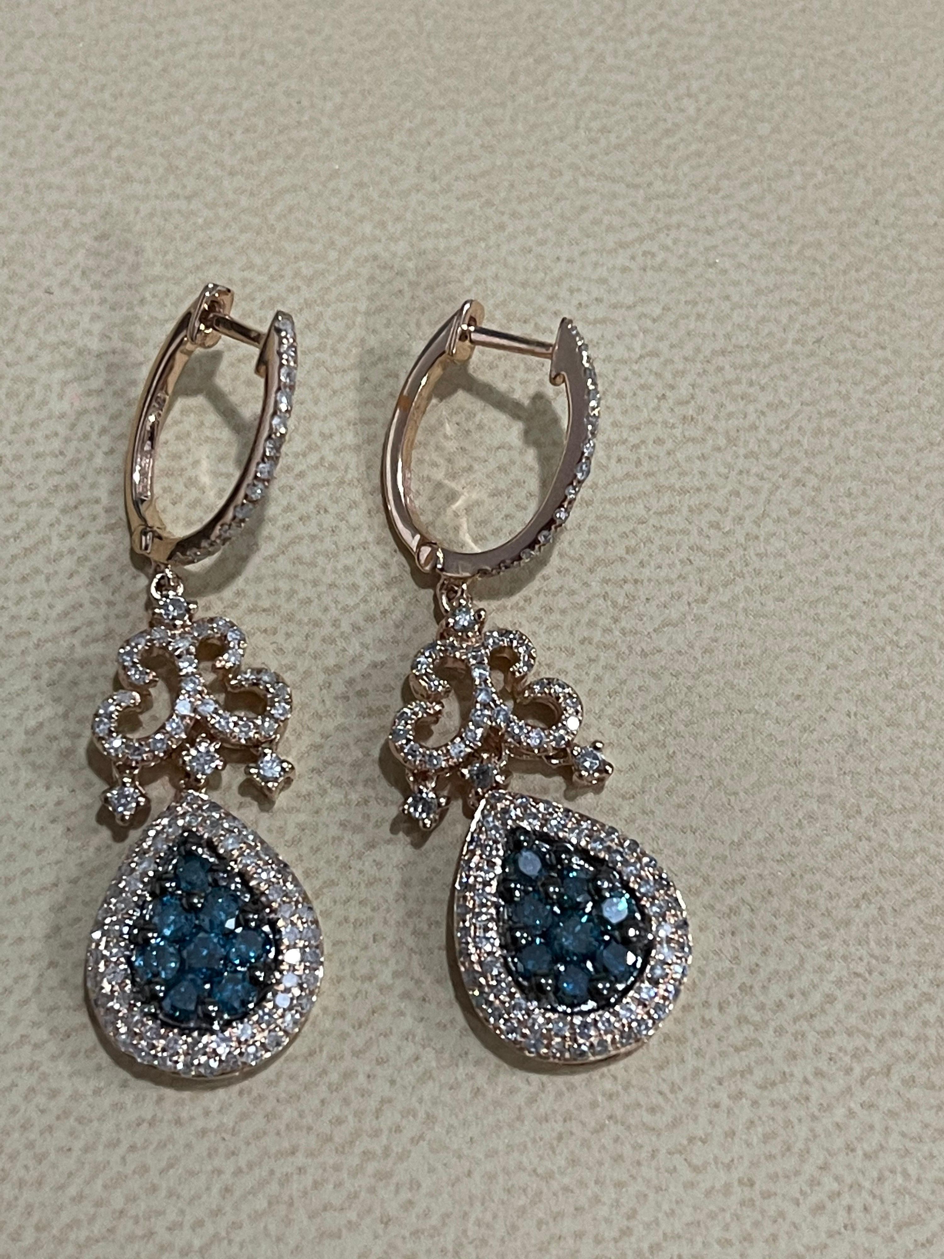 
Designer Effy's 1.72 Carat Blue & White Diamond Dangling Earrings 14 K Rose Gold
 Small Huggies on the top . 
This exquisite pair of earrings are beautifully crafted with 14 karat Rose  gold .
Weight of 14 K gold 7 grams
Fine Round Cut Blue