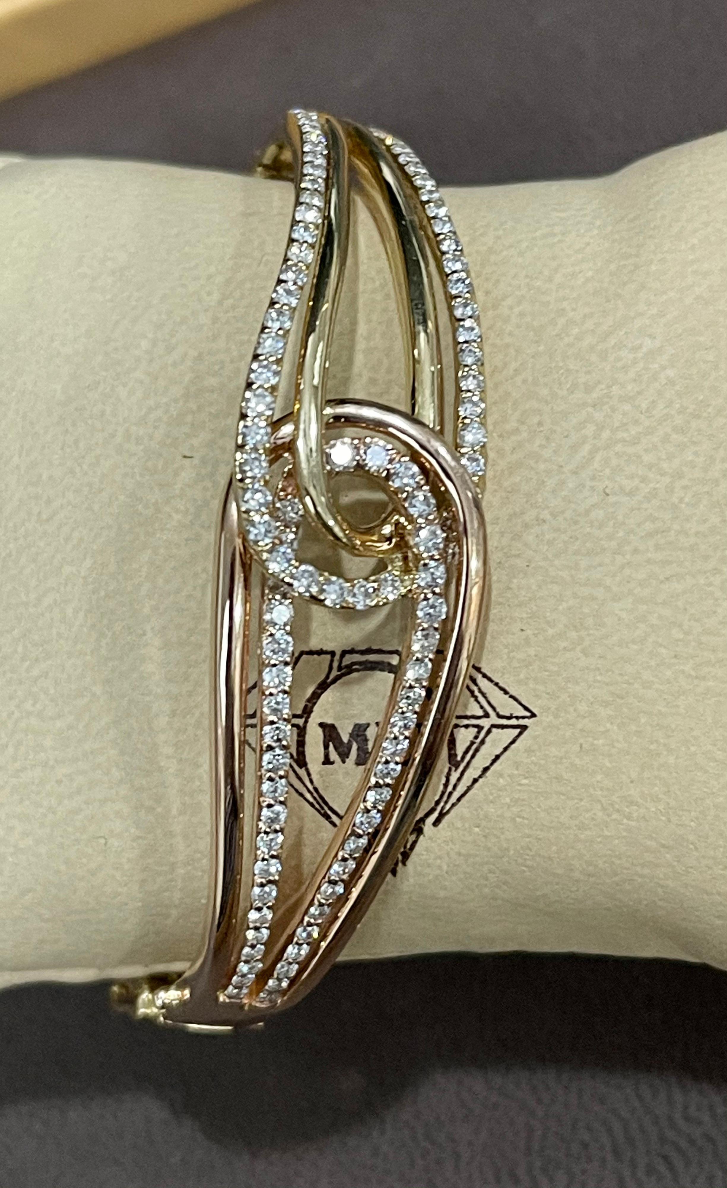 Designer piece for affordable price
Designer Effy's  1.88 Carat Diamond 14 Karat Rose and yellow  Gold Bangle 
Set with two sides coming in the middle m 0ne side is in yellow gold and other side is in Pink or rose Gold.
Half   Eternity Bangle