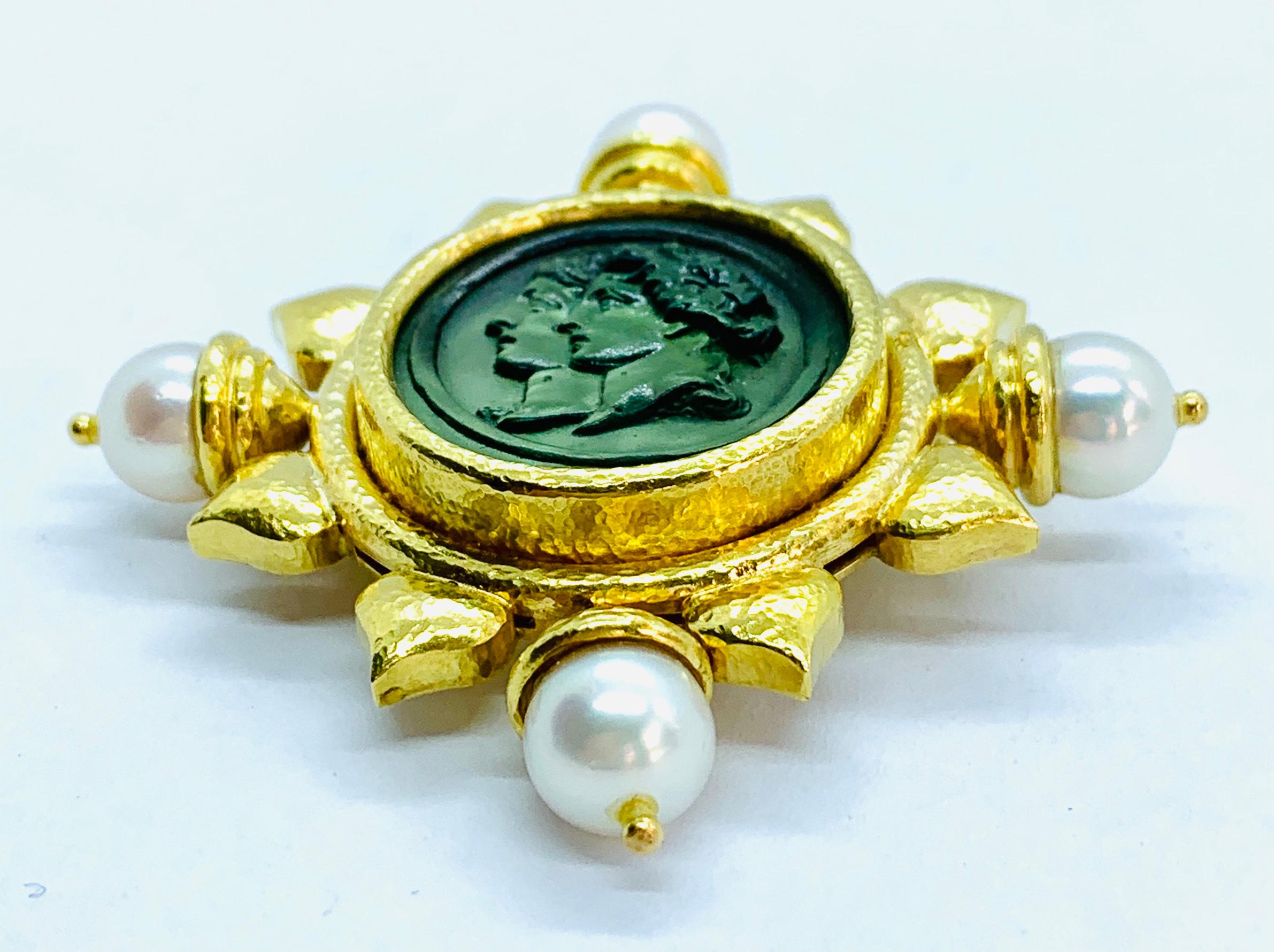 This is a gorgeous and rare vintage piece! Designer Elizabeth Locke piece that can be worn as a brooch or a pendant. It is made in 18K yellow Gold with four round pearls with a carved green intaglio at the center. The piece measures 2 by 2 inches