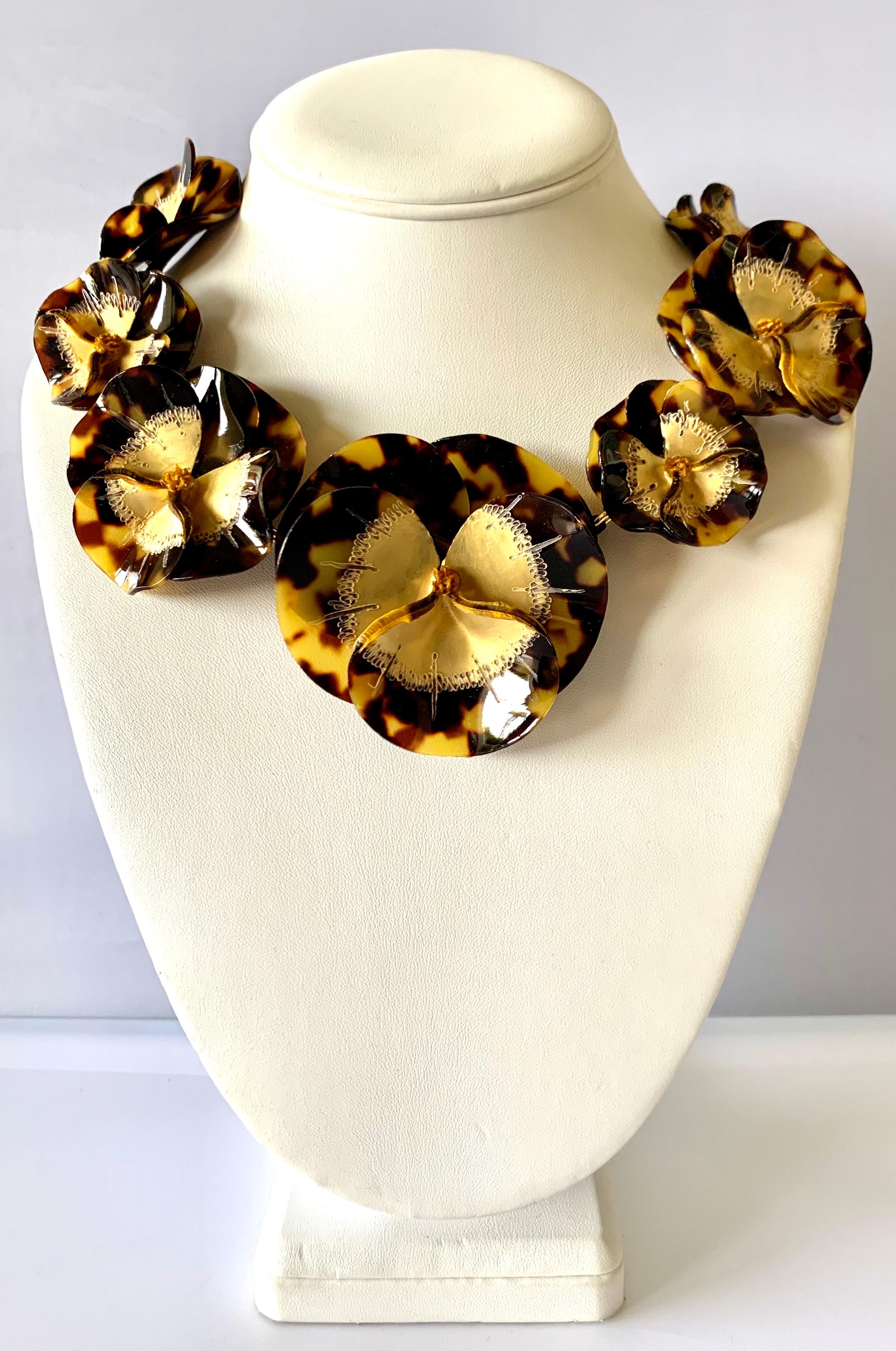 Contemporary artisanal necklace comprised out of seven faux tortoise three-dimensional pansy flowers - the flowers are gold-leafed at the center giving the necklace depth and sophistication. Handcrafted in France by Cilea Paris.