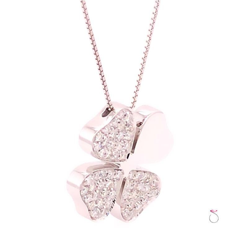 Gorgeous four leaf clover diamond pendant in 18k white gold on chain. This stunning pendant features three diamond pave' set leafs and one high polish white gold leaf. Fifty seven (57) round brilliant cut diamonds totaling approximately 1.00 carat.