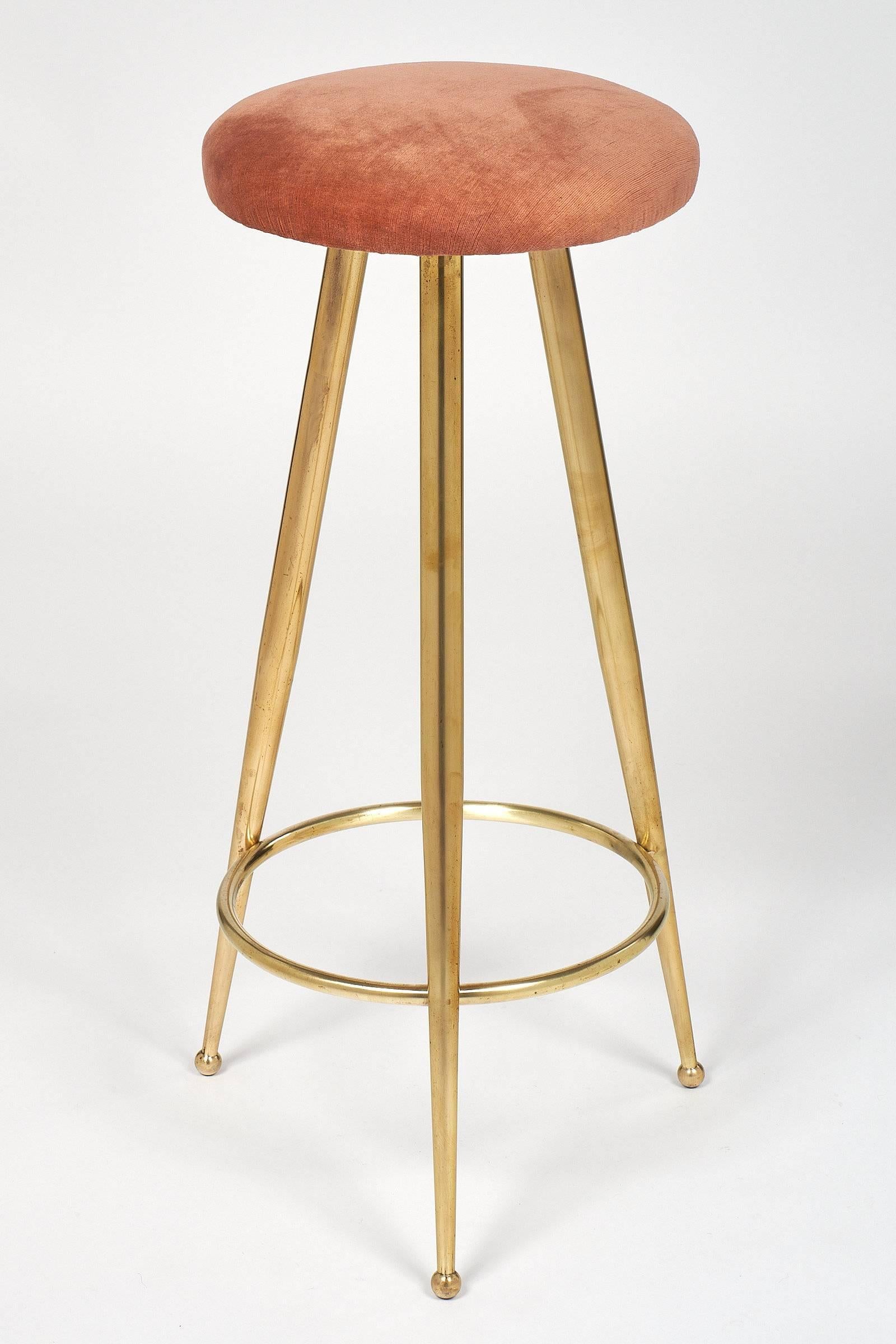 From a Hotel in Milan, a pair of brass bar stools in the manner of Gio Ponti, featuring a tripod base with tapered legs. The legs are braced with a circular stretcher and have spherical brass feet. Very strong craftsmanship and design typical of