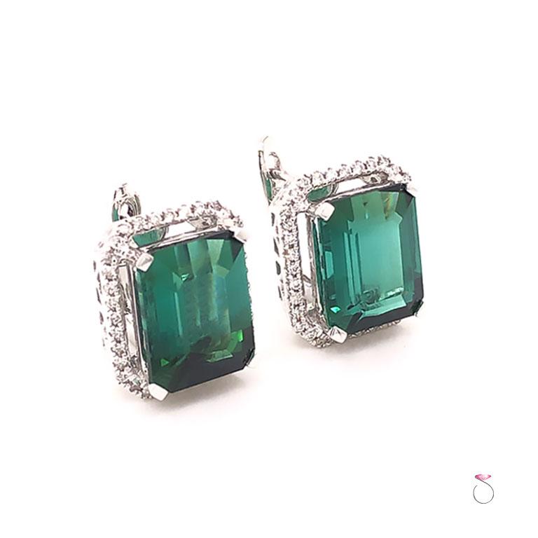 Gorgeous natural Green Tourmaline & Diamond halo Earrings in 18K white gold. These beautiful Earrings feature Two emerald cut green Tourmalines set in four prongs and surrounded by a diamond halo. The Tourmalines measure approximately 9.98 x 7.98 x