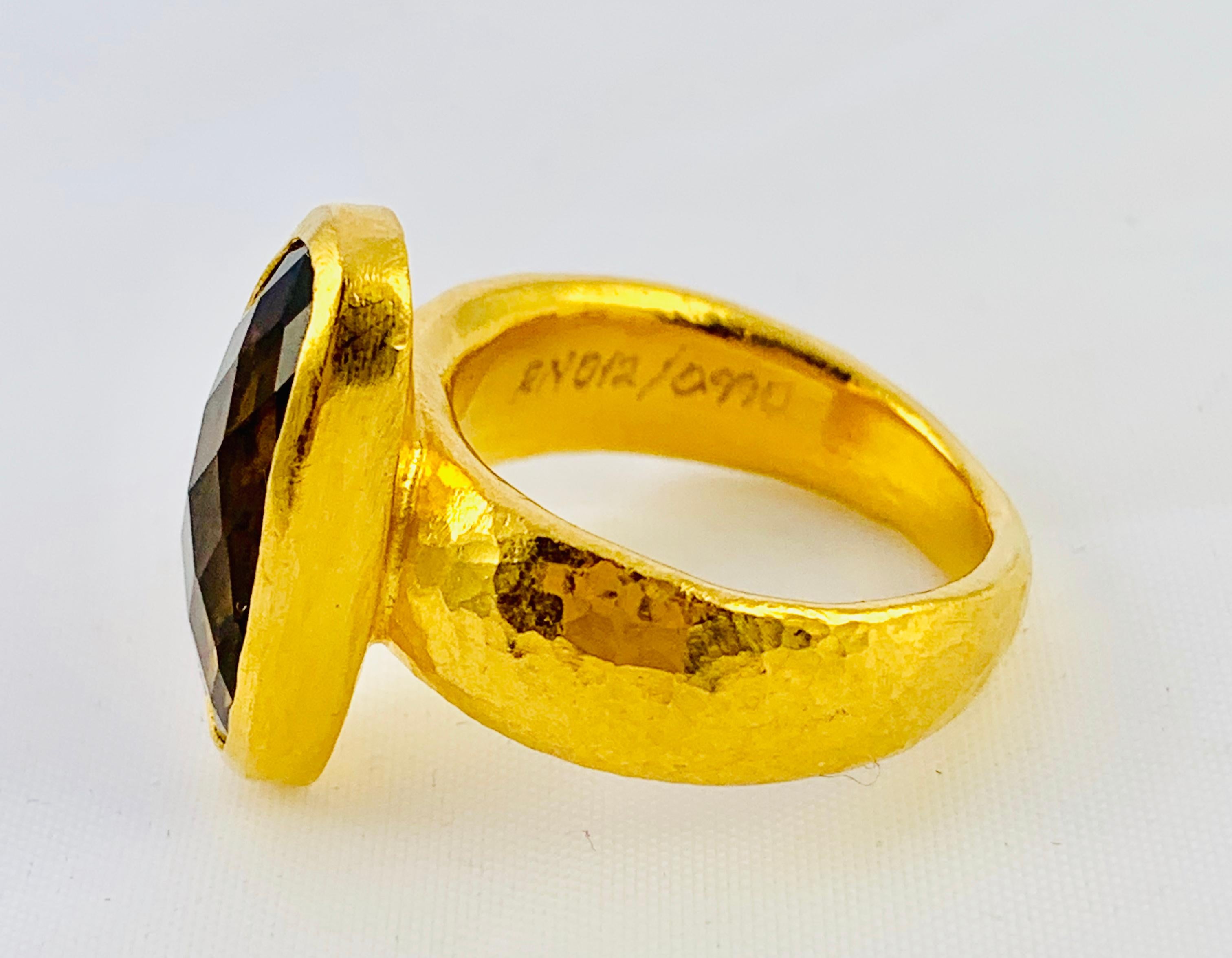 Gorgeous Designer Gurhan Hammered 24K yellow Gold And Smoky Topaz Ring! It weighs 8.8 grams and is size 5.75. The Topaz measures 6.6mm by 16.68mm and the band is 7.2mm wide.. Per the Gurhan website:
