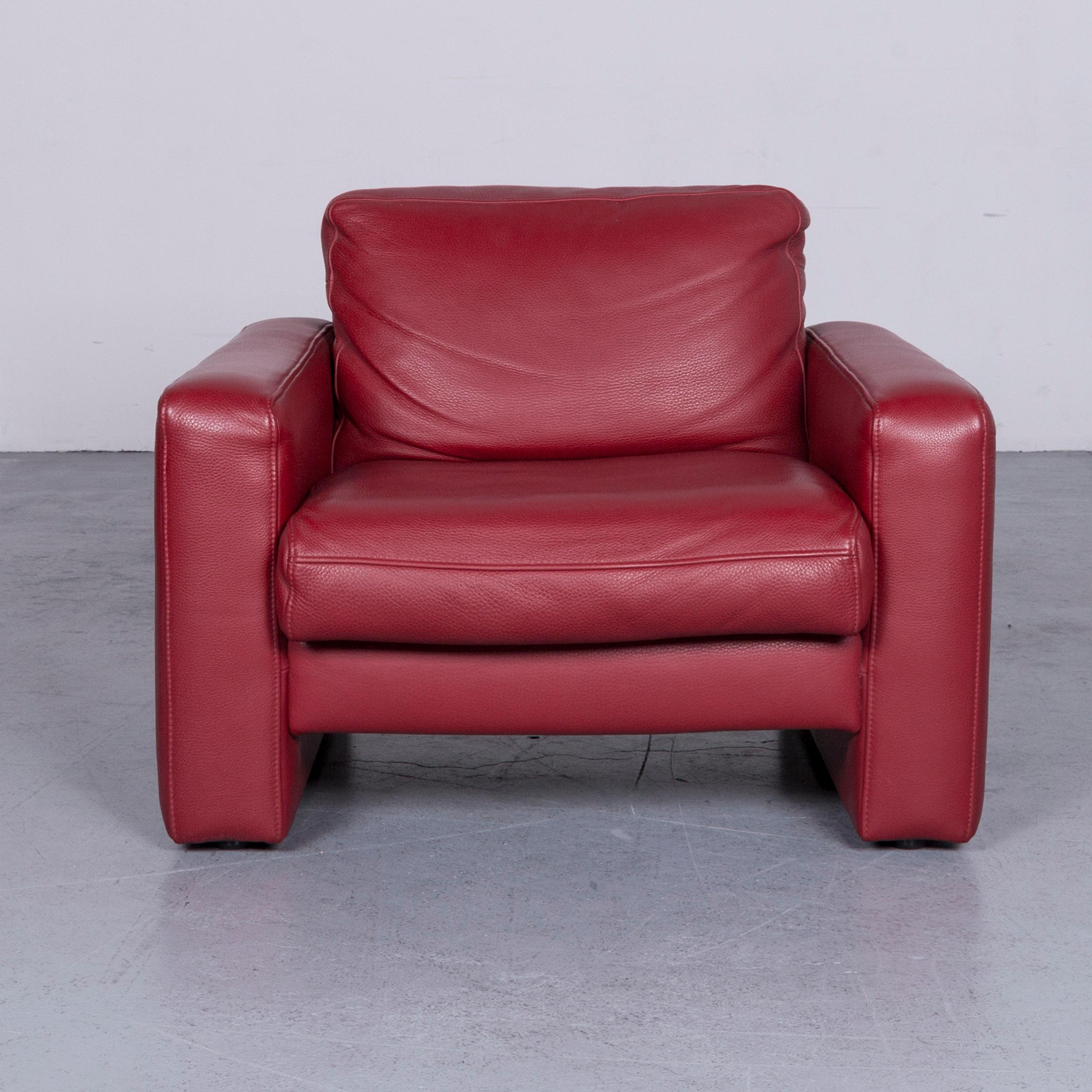 Red colored designer leather armchair in a minimalistic and modern design, made for pure comfort.