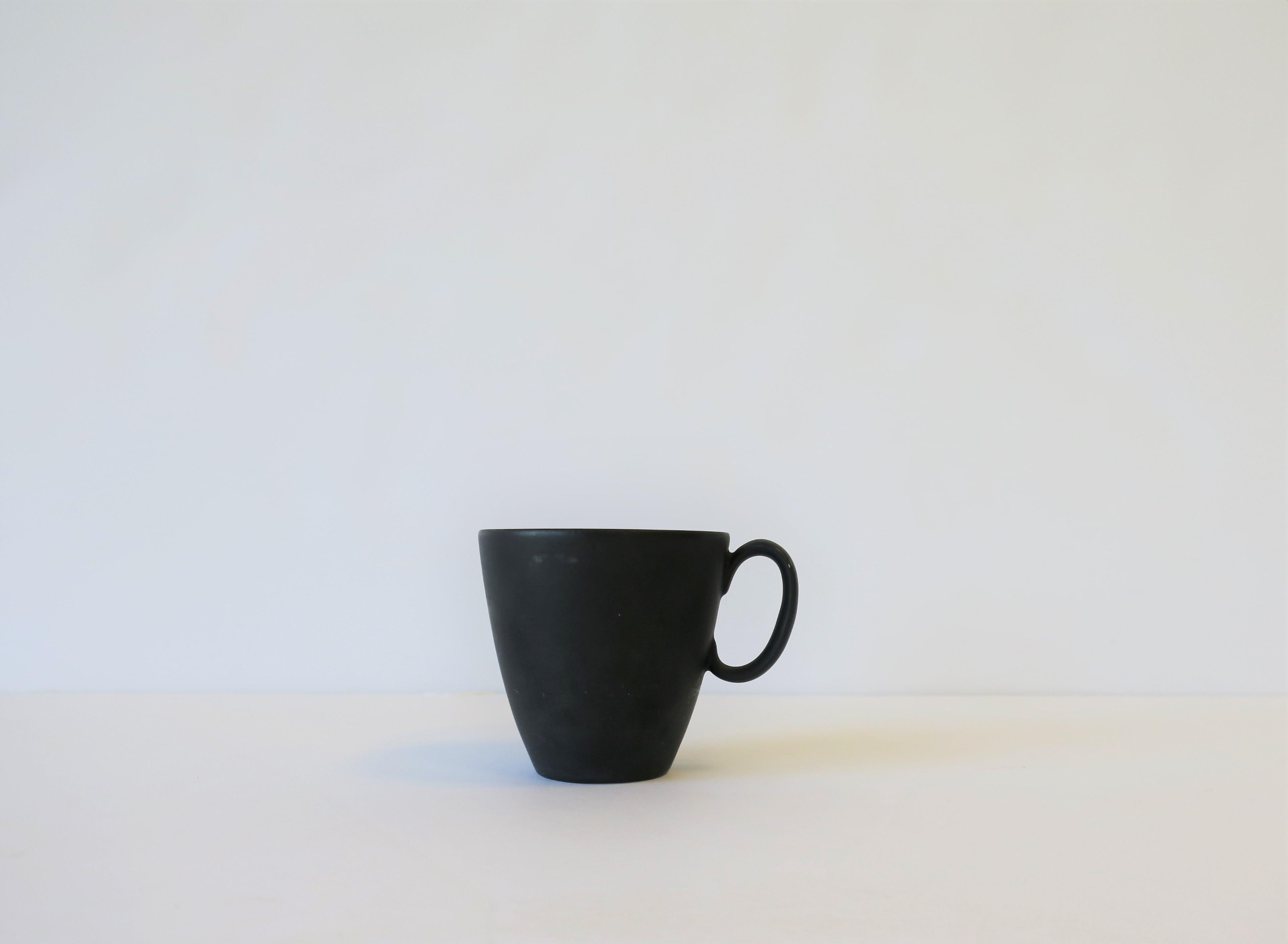 A beautiful matte black or 'charcoal' and white espresso coffee or tea demitasse cup by designer Raymond Loewy. Porcelain cup has a matte black or 'charcoal' exterior and a white glazed interior. With maker's mark on bottom as show in image #7. Made