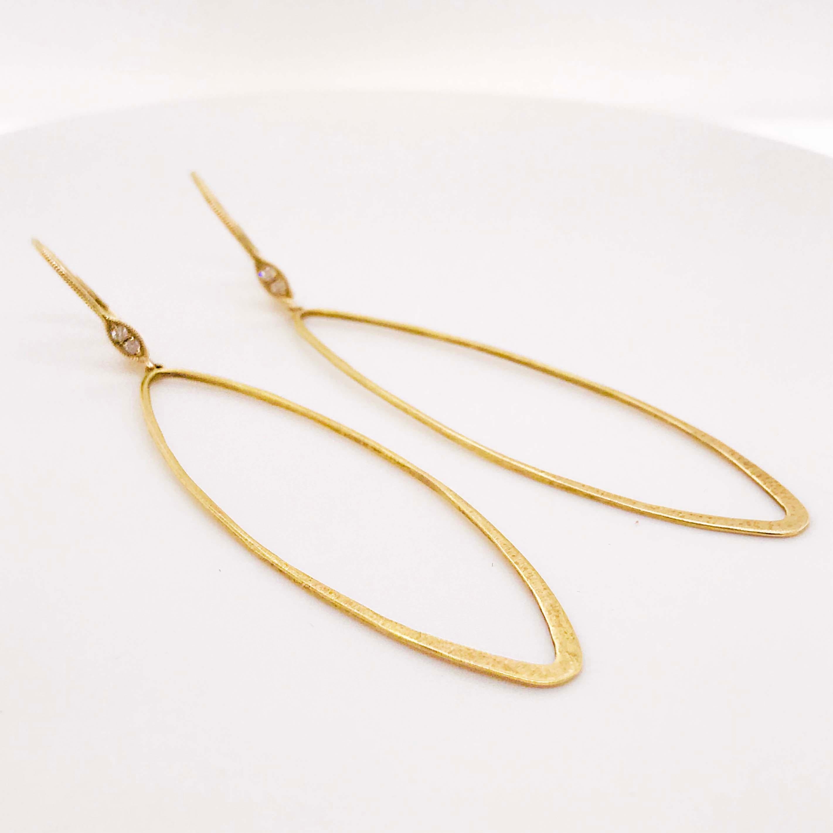Meira T Designer modern diamond fashion drop earrings in 14 karat yellow gold! The designer diamond earring drops have an open oval design that is elongating and accentuating! With a retro shape and modern finish, these are unique and fun! With the