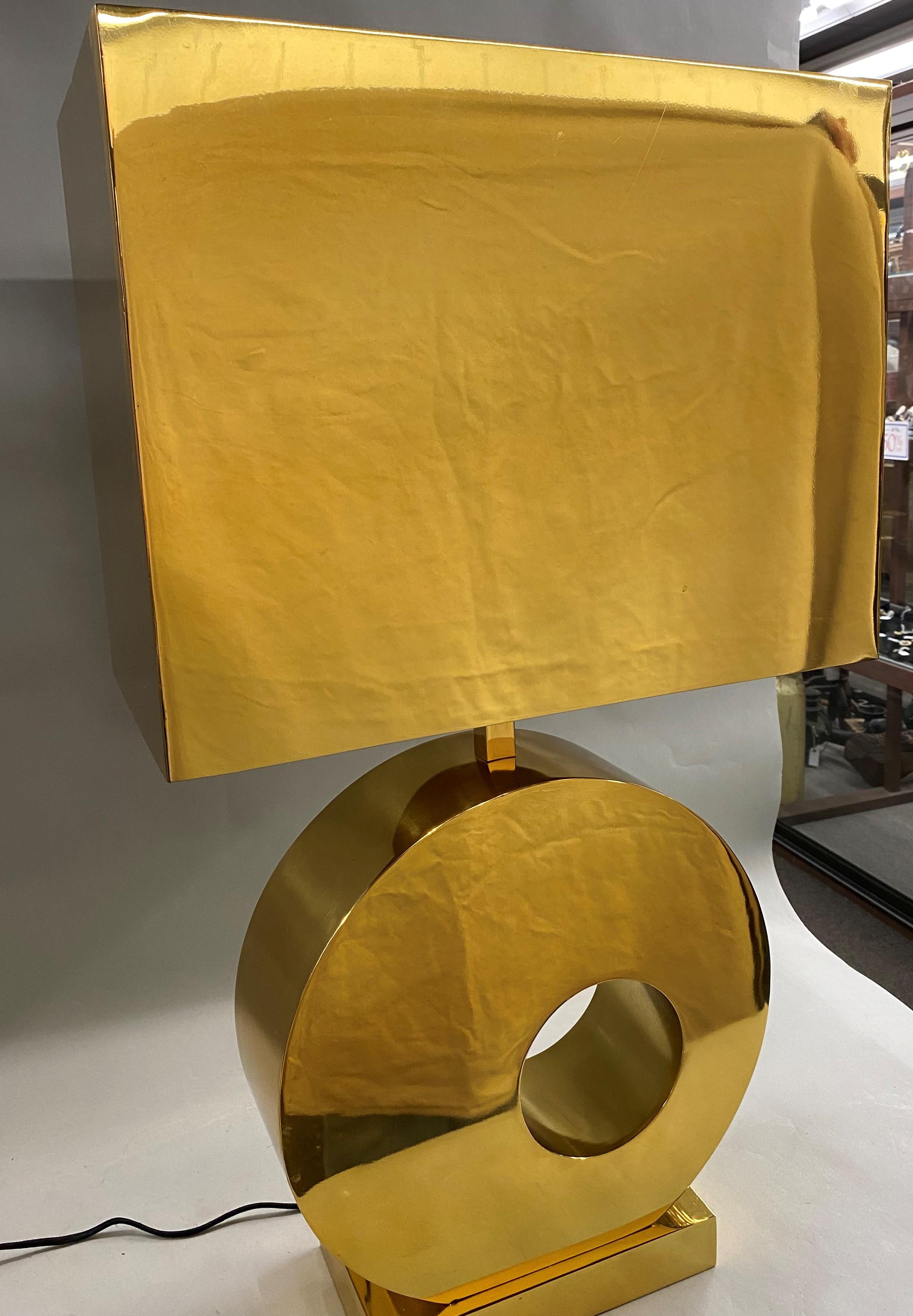 A fine designer modernist heavy bronze or brass two light table lamp with rectangular shade and round donut form body with rectangular felt lined base. This vintage lamp dates to the second half of the 20th century and is in very good working