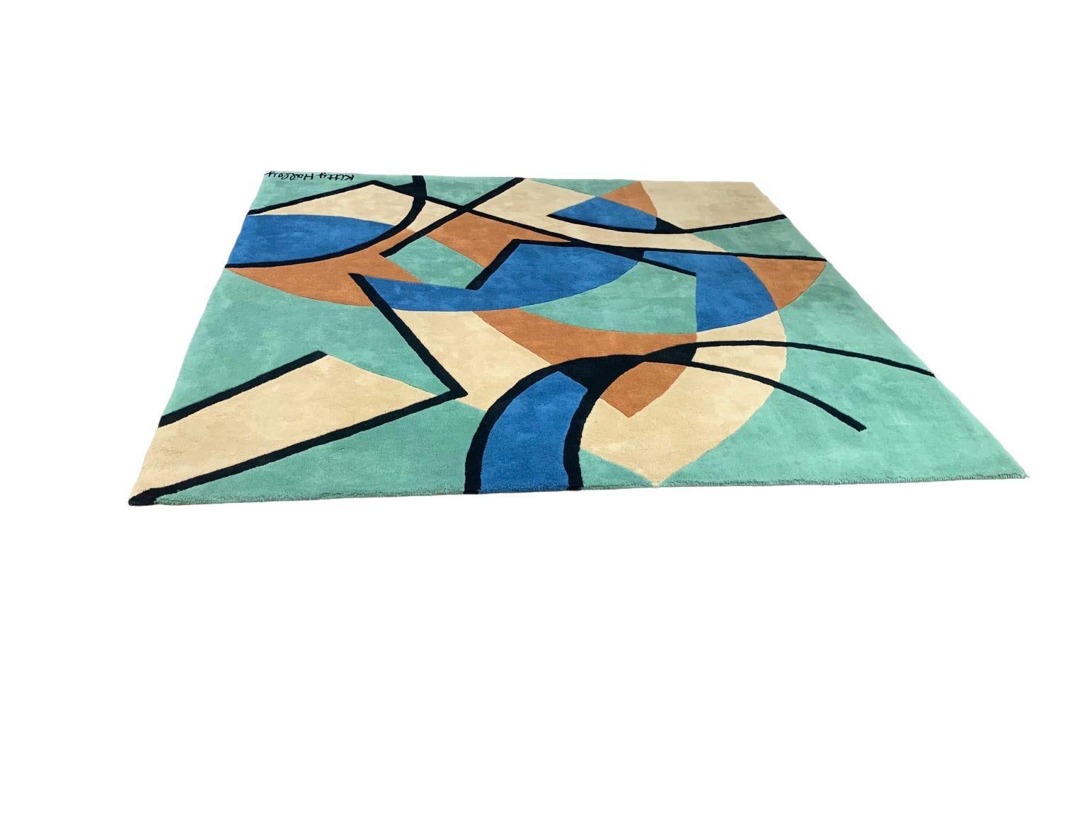 Designer, modernist geometric area rug. Design By ETE Diffusion Circa 1980’s marked Kitty Halley. Tag on back marked made in Inde (India) 100 percent Laine(wool). Incredible vibrant geometric shape design.  Dimensions 88 inches by 86 inches.