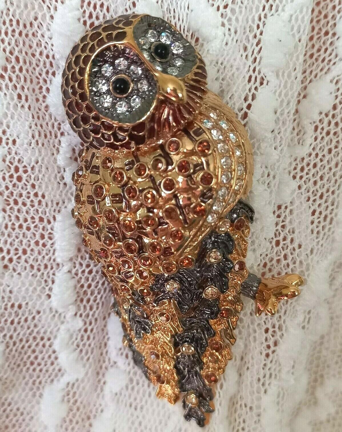 Simply Beautiful! Rare Designer Brooch by Nolan Miller featuring an Owl set with Sparkling Crystals and Enamel accents. Dimensional Multi Gold Tone mounting. Measuring approx. 1.75