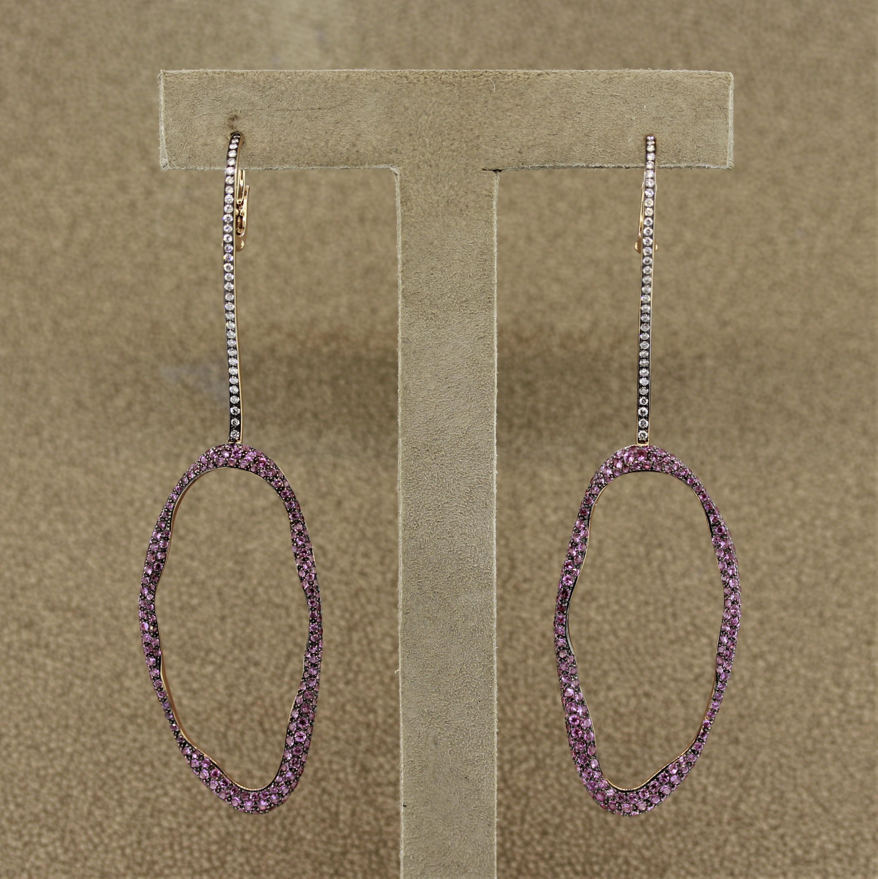 A fine pair of earrings featuring 3 carats of pink sapphire cut as round brilliants along with 0.70 carats of round brilliant cut diamonds. Made in 18k rose gold with a black rhodium finish on the top of the earrings.

Length: 3.4 inches