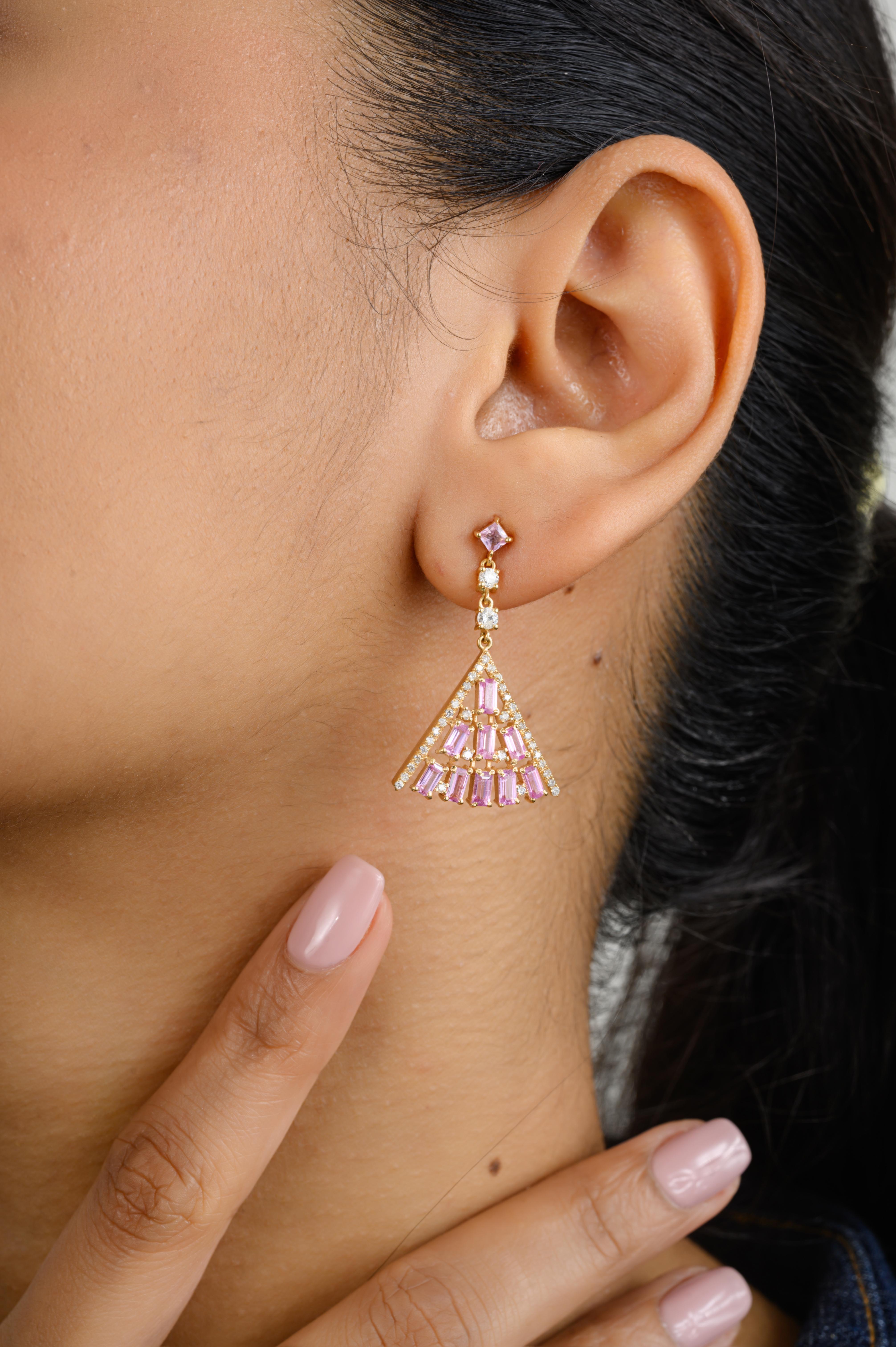 Designer Pink Sapphire Pyramid Dangle Earrings for Wedding in 18K Gold to make a statement with your look. You shall need dangle earrings to make a statement with your look. These earrings create a sparkling, luxurious look featuring baguette and