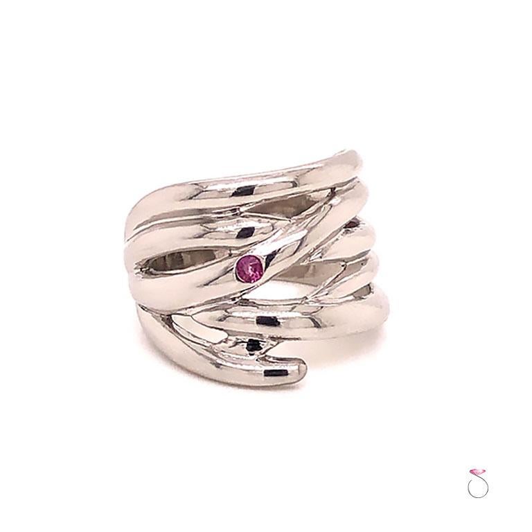 Beautiful Designer Ruby wide band in platinum by TAPIRUS. This stunning band is crafted in platinum 900 with high polish finish. The band is 16.80 mm wide featuring six criss crossing lines with one inset round Ruby on the side of the band.  The