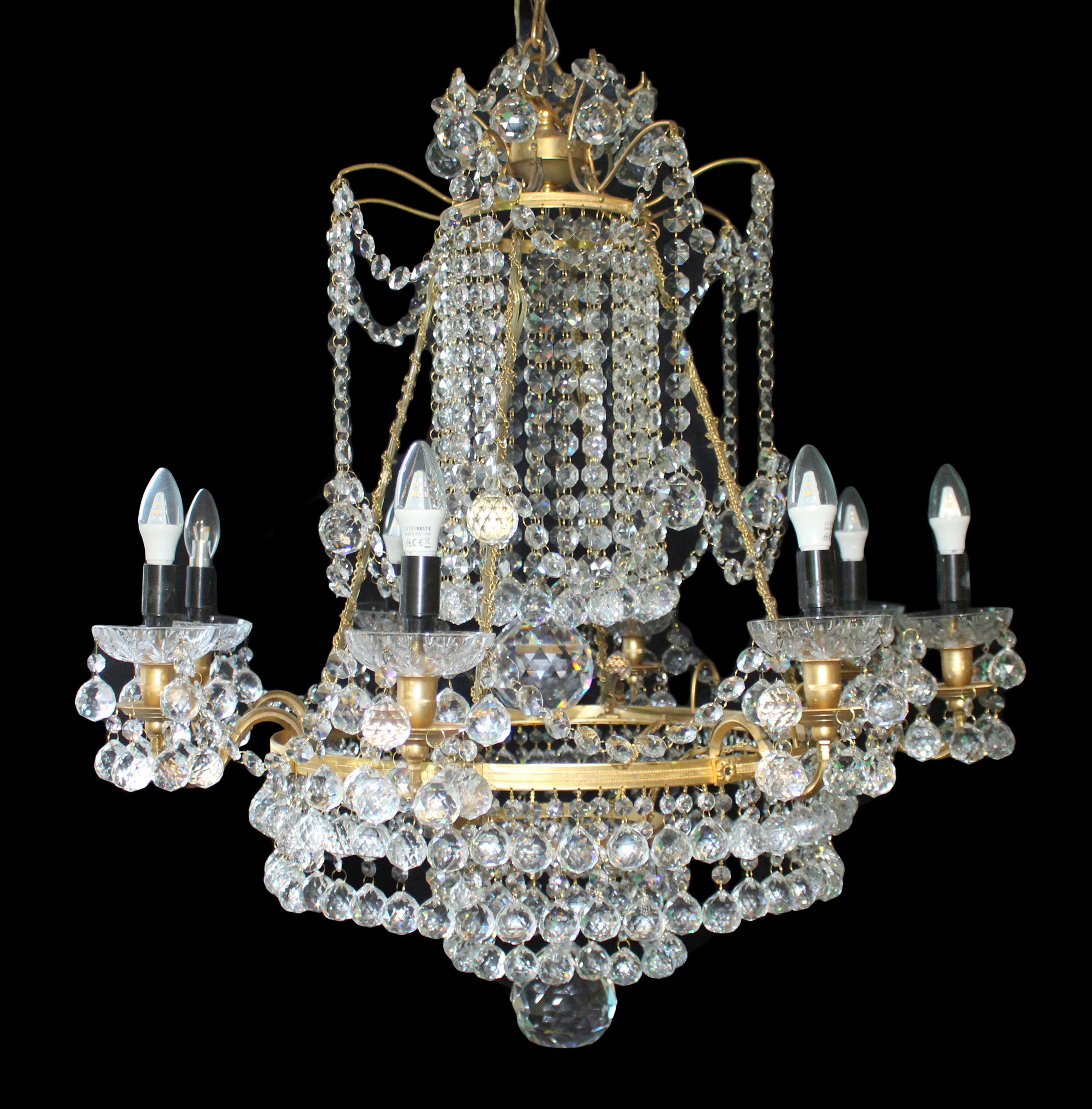 Period late 20th c., purchased in New York

Composition Heavy gilt metal frame. Profusely dressed in high quality crystal lustres with crystal sconces. Magnificent large crystal balls to the middle and bottom

Measures: Width 85 cm / 33 1/2