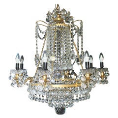 Lustre de créateur en métal doré et cristal abondamment habillé