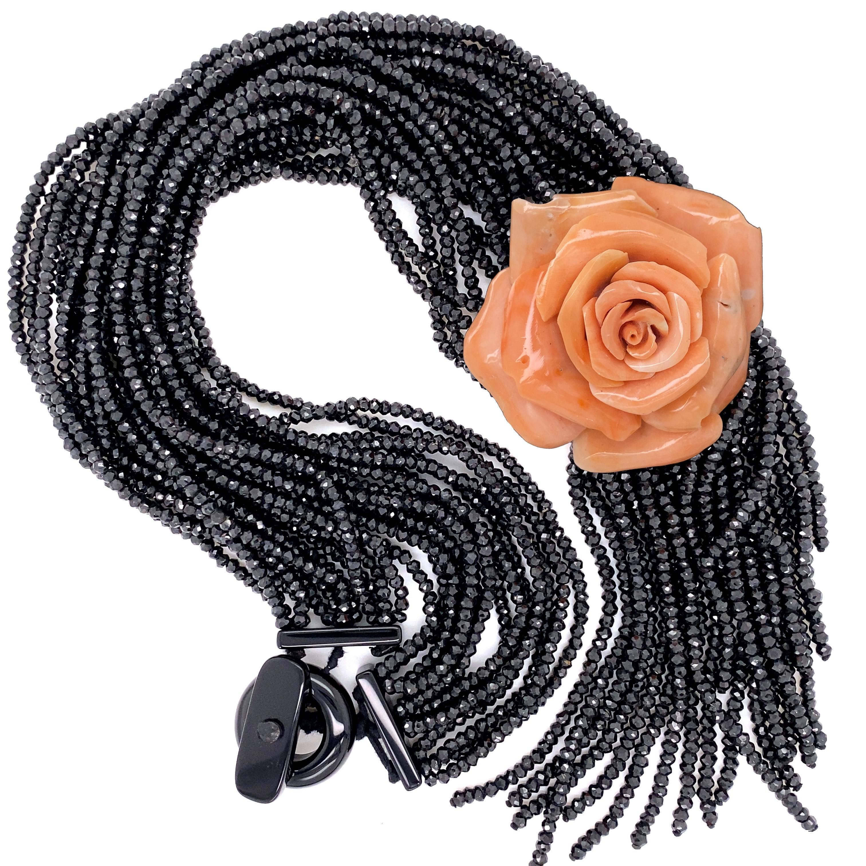 Simply Beautiful! Stylish Rare Designer Rosita Petrosino Couture Multi-Strand Necklace, featuring Black Spinel Beads, weighing approx. 700 Carat, a 125 Carat Carved Coral Rose.  Approx. length of necklace: 20”. Unique and fabulous as you are! A