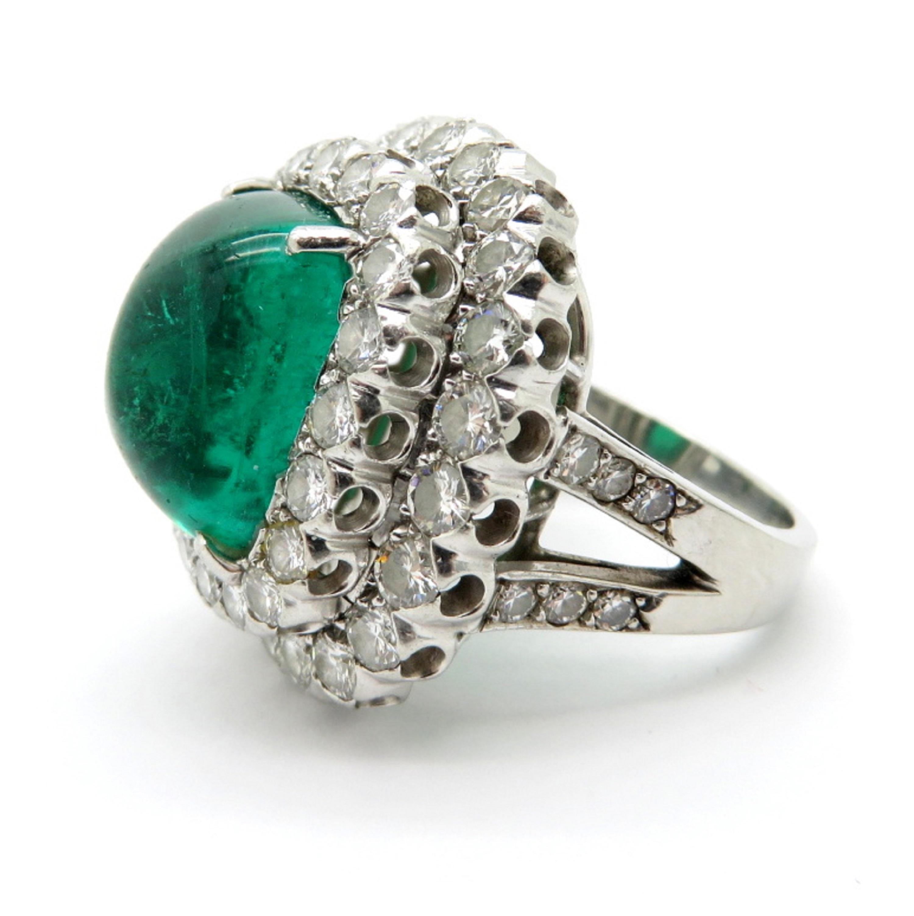 Designer Ruser AGL certified platinum large emerald and double halo diamond ring. Centering one 7.50 carat Sugarloaf emerald.  Interspersed with 43 round brilliant cut diamonds weighing a combined total of 3.00 carats. The diamonds are bead and
