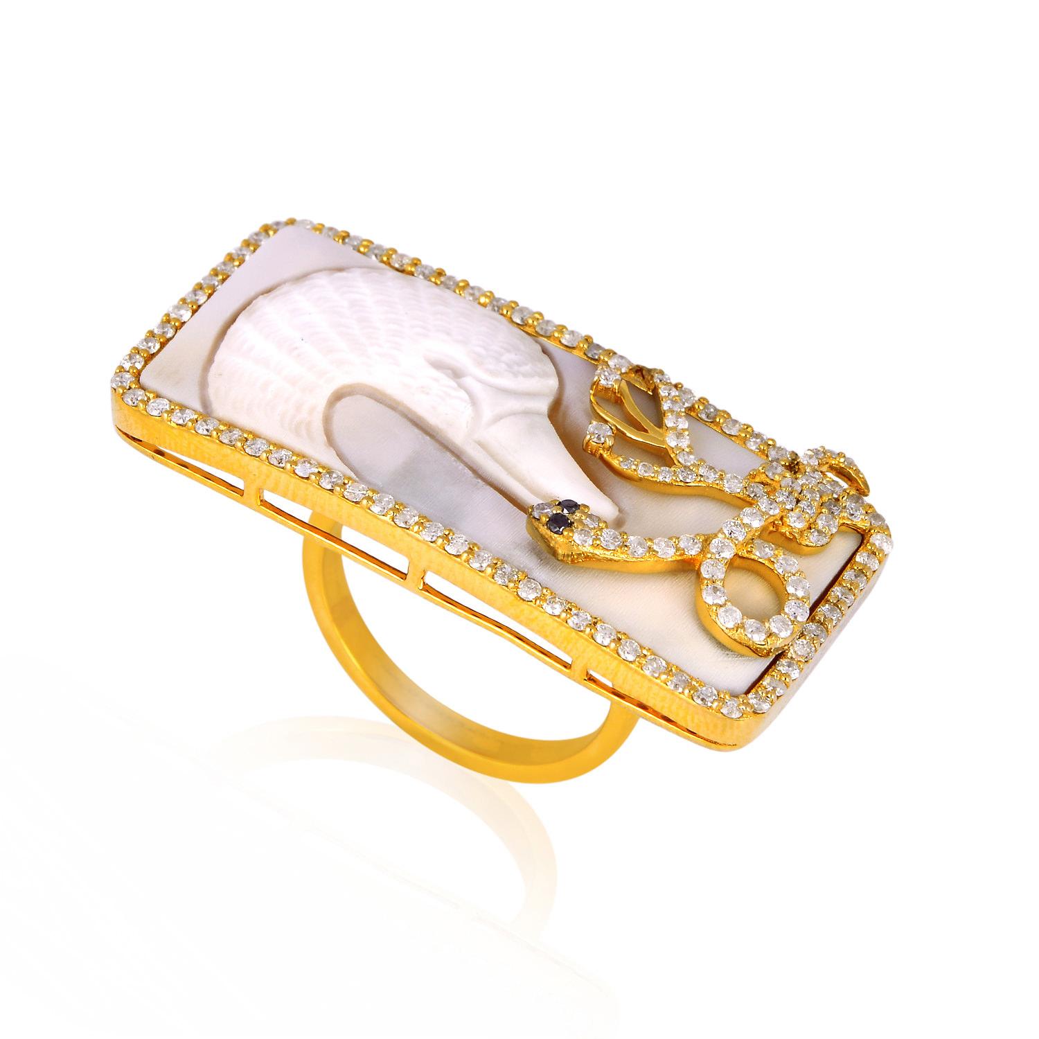 Designer Swan Shell Cameo Ring with Diamonds 18k Gold covering your 2 fingers is one of our favorite pieces. This shell cameo has been hand carved by an Italian artisan.

Ring Size: 7 ( Can be sized )

18Kt Gold: 9.91gms
Diamond: 0.93cts
Shell
