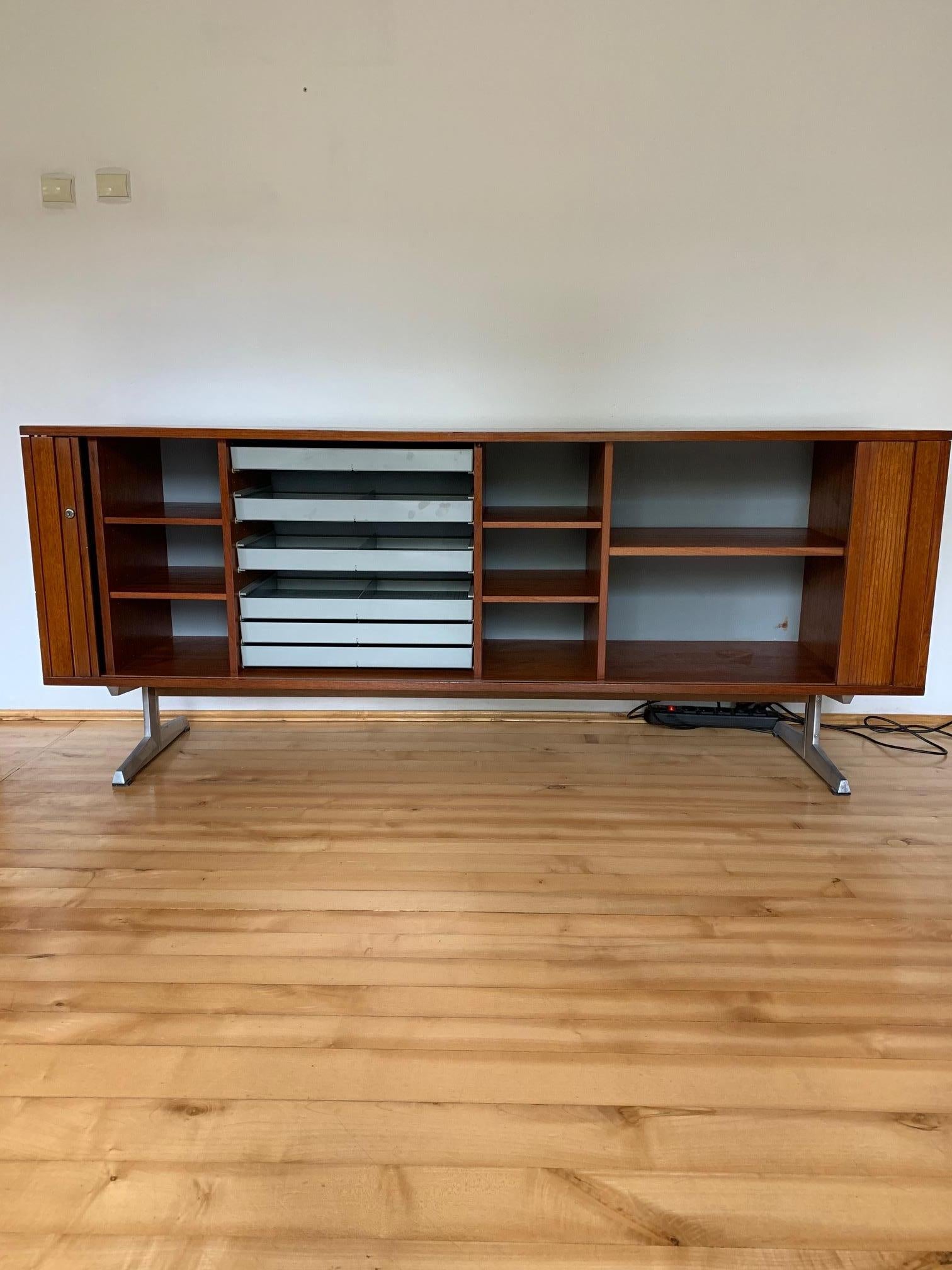 Sideboard of the first generation, designed by Marius Byrialsen, Nipu, 1960s. In original condition and signed. The sideboard has not undergone any renovation. Door in the form of blinds. Perfect and very attractive performance. A Classic of Danish