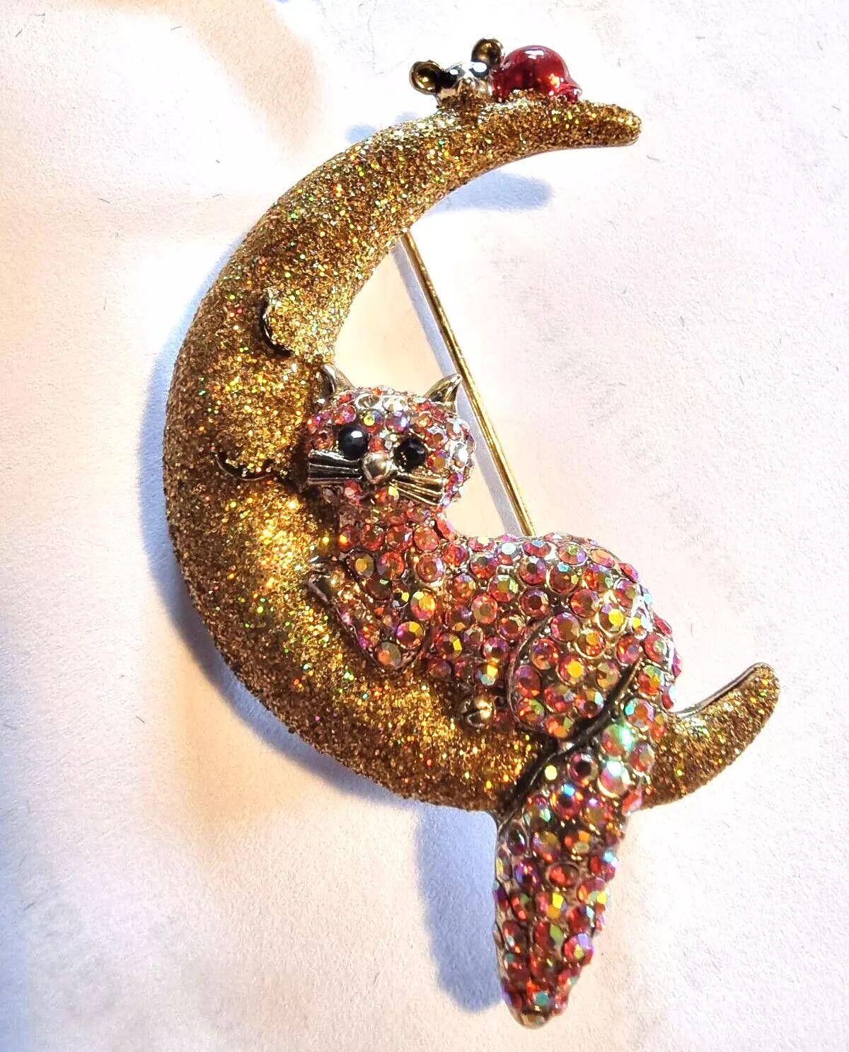 Simply Beautiful!  Designer Signed Butler and Wilson Sparkling Golden Crystal Cat and Tiny Mouse perched on a Crescent Moon Brooch Pin. Hand set with encrusted Sparkling Golden Crystals. Gold tone mounting.  Measuring approx. 7 cm High. Comes in B&W