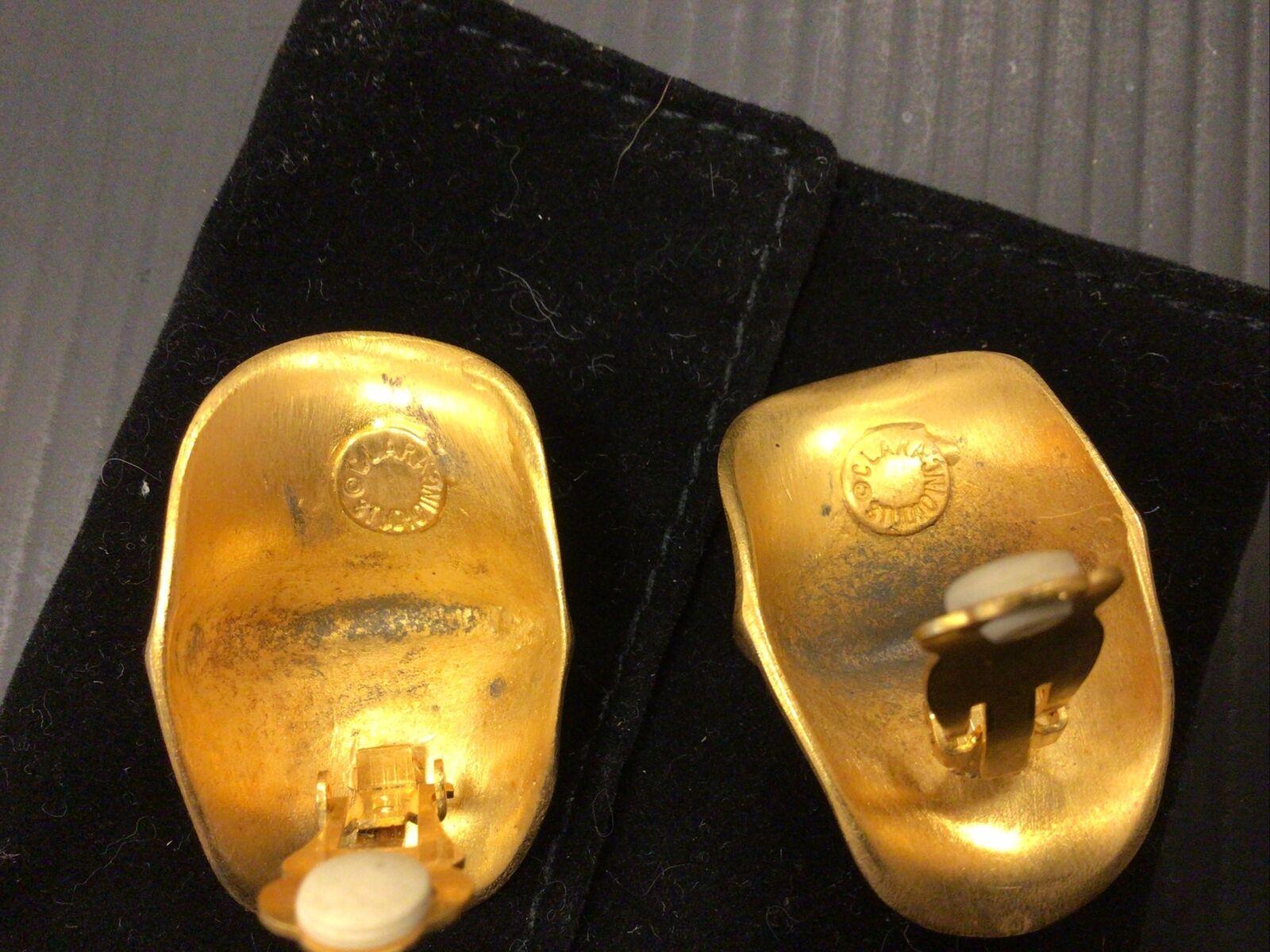 Simply Beautiful Designer Signed Clara Studio Inc. Brushed Gold tone Modern Clip-on Earrings. Measuring approx. 1.75