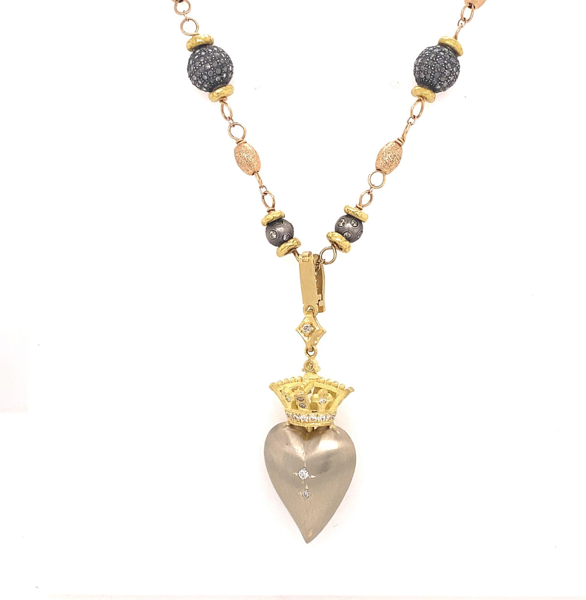 
This is a stunning necklace by Los Angeles custom designer Kisum Inc.  The pendant portion is a pave diamond heart in white gold with a yellow gold crown. Estimated diamond weight for the pendant 2.9 carats.  The diamonds average I color VS-2