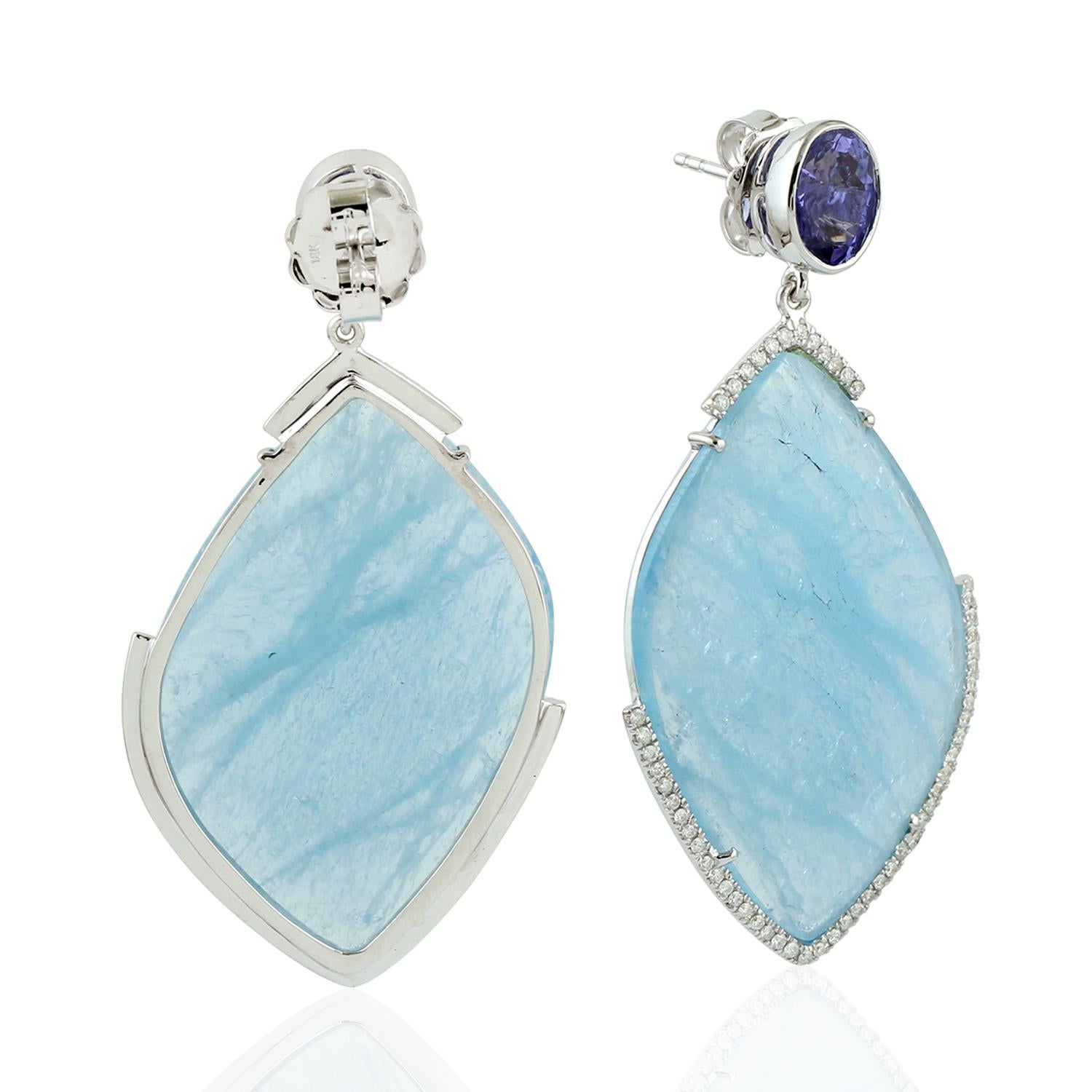 Designer Slice Aquamarine, Tanzanite & Diamond Drop Dangle Earring in 18K White Gold is lovely for gifting to your loved one!

Closure: Push Post

18KT Gold:8.441gms
Diamond:0.58cts
Aquamarine:48.45cts
Tanzanite:4.72cts
