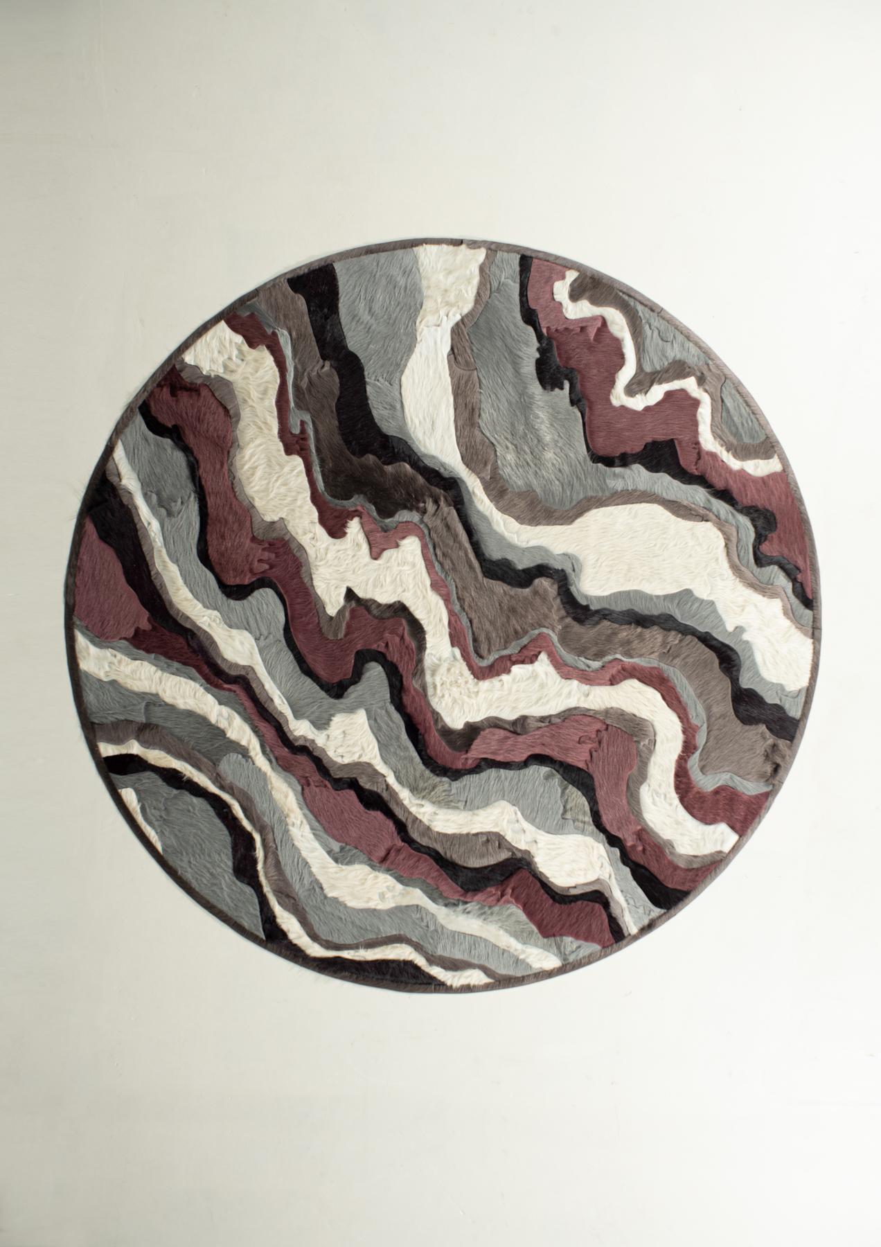 This Submerge Hide Rug was designed in collaboration between Kyle Bunting and Interior Designer Marc Thee for their 2018 rug collection. 

About the Design:
Through extreme heating and cooling, magma builds, overflows and cumulates, creating the