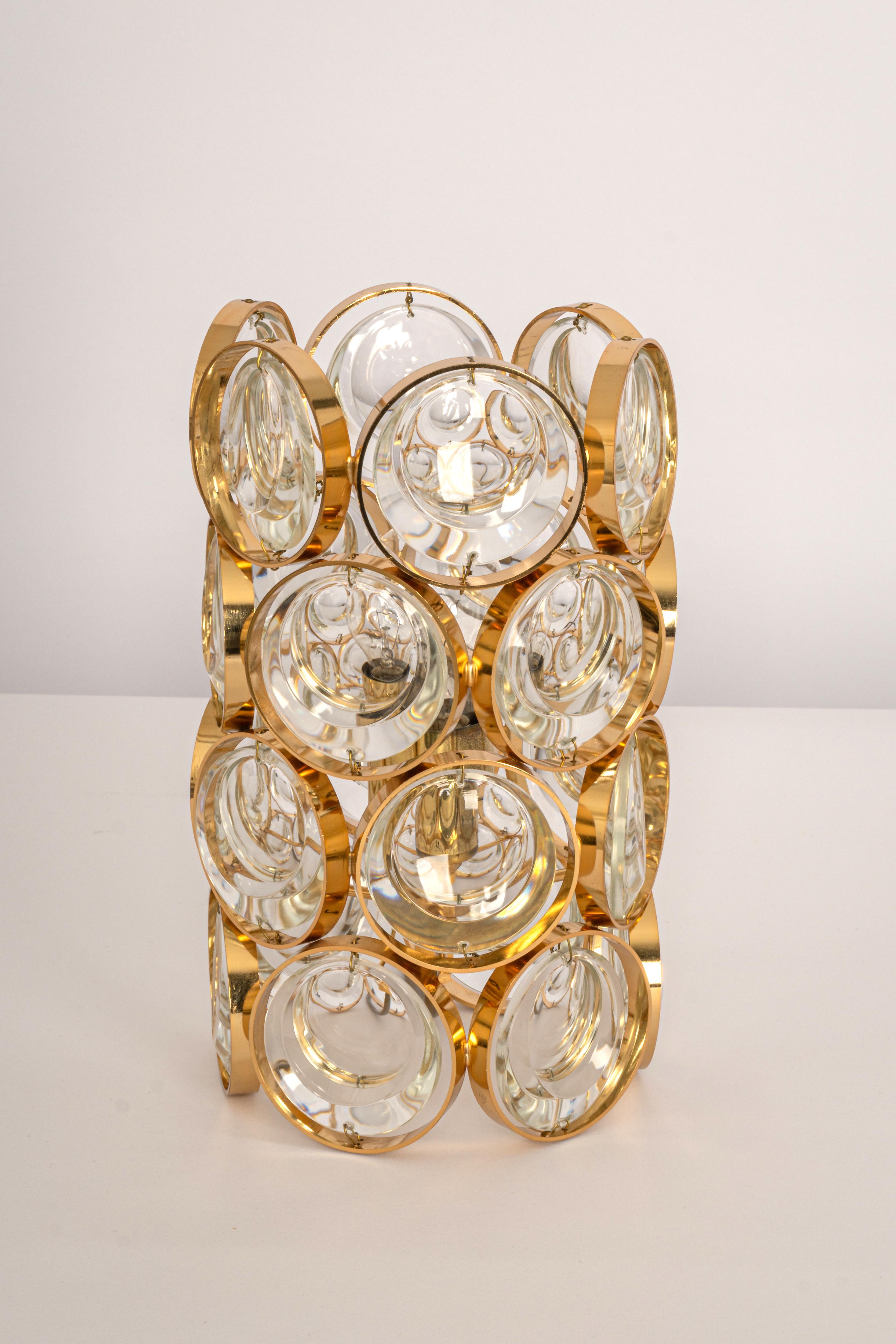 Designer table lamp by Palwa, in the style of Sciolari, Germany, 1960s
Gilded brass frame and crystal glass rings.

Sockets: The table lamp needs one x E27 standard bulb to illuminate.
Light bulbs are not included. It is possible to install this