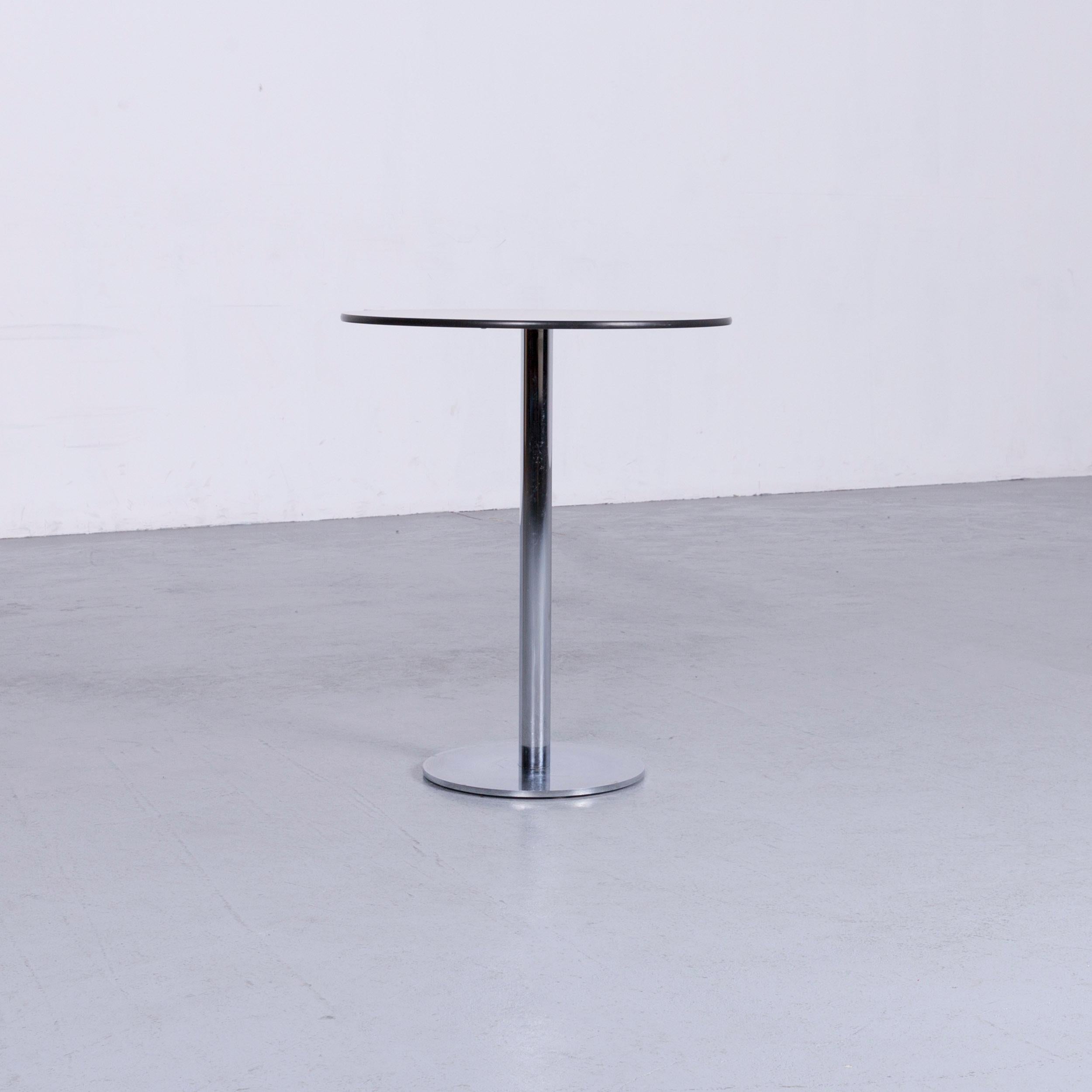 Silver grey colored Swiss air lounge designer table, in a minimalistic and modern design.