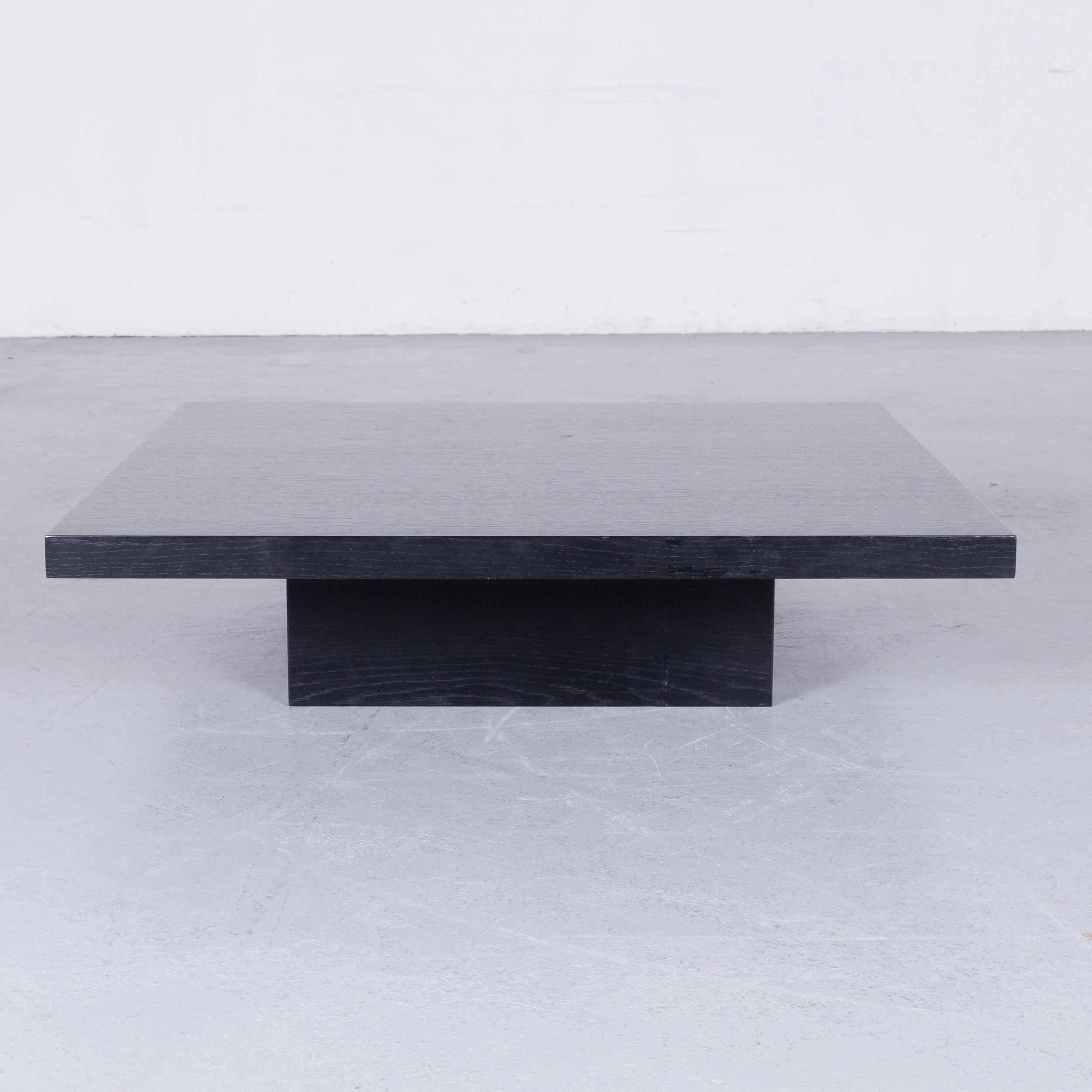 Black colored wooden designer sofa table, in a minimalistic and modern design, made for pure style.